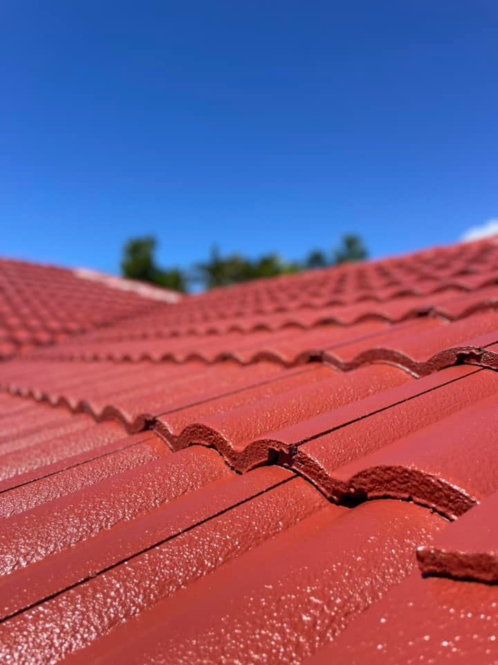 Red Tiled Roof Under a Bright Blue Sky — SEQ Roofing & Painting in Coolangatta, QLD