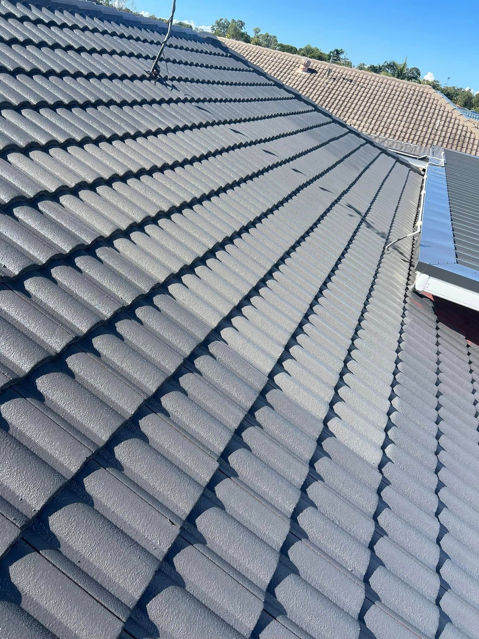 Gray Tiled Roof Under a Bright Blue Sky — SEQ Roofing & Painting in Tugun, QLD