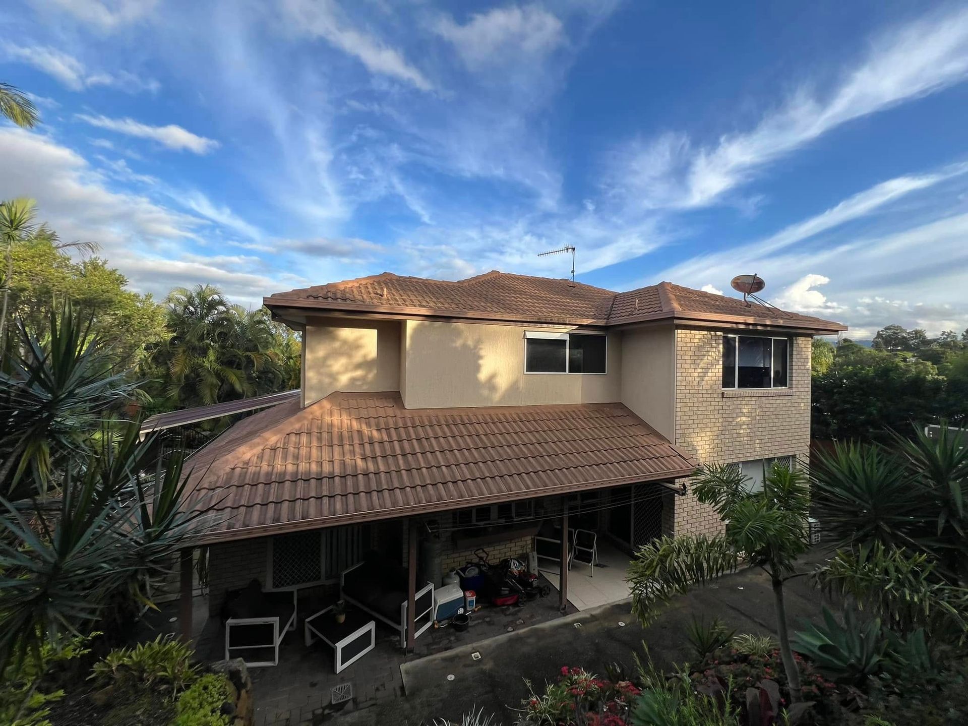 Two-story House With Brown Tile Roof, Tan Stucco Walls, and Porch — SEQ Roofing & Painting in Tugun, QLD