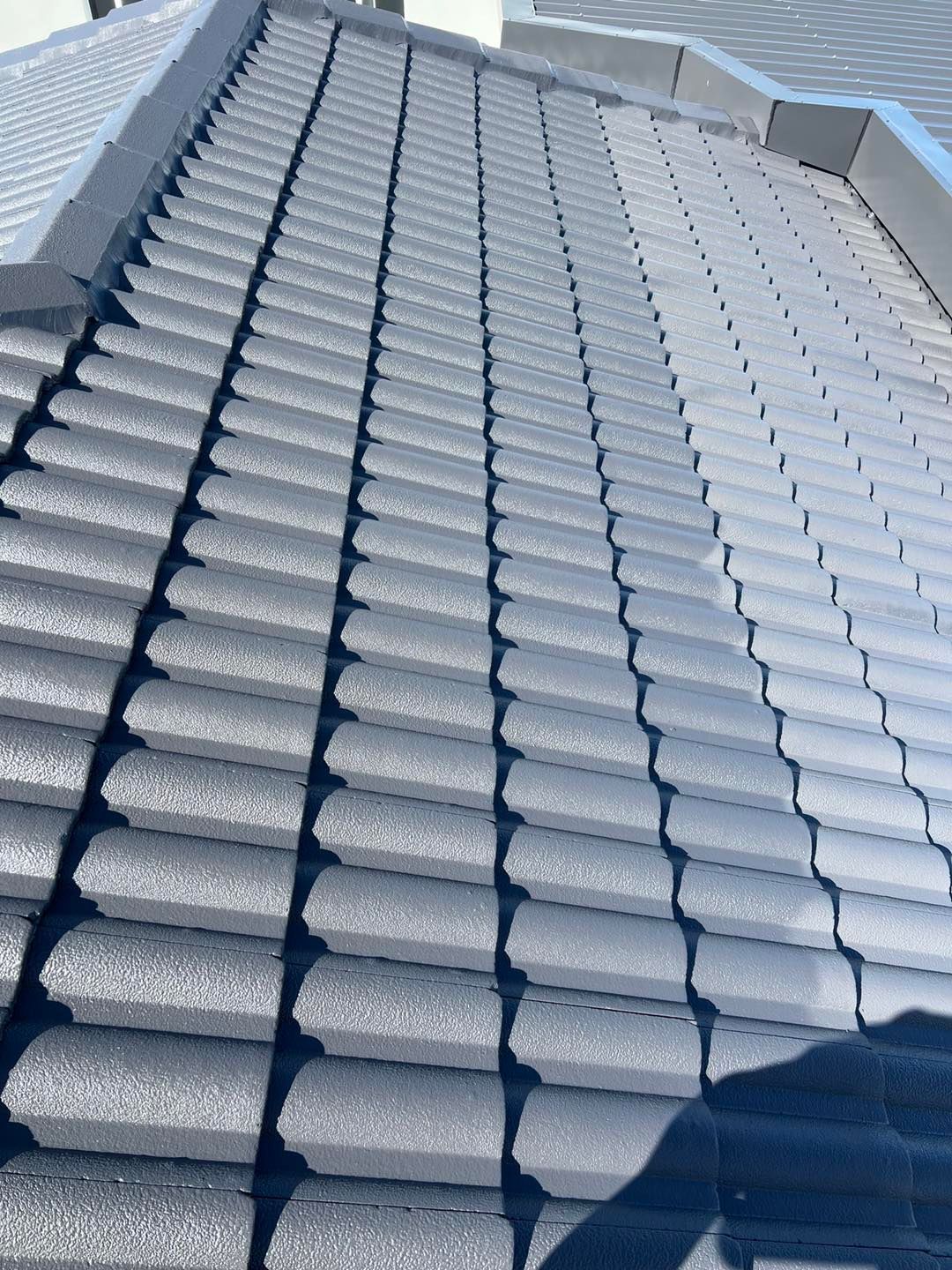 Gray Tiled Roof Angled Towards the Viewer, Showing Rows of Tiles — SEQ Roofing & Painting in Nerang, QLD