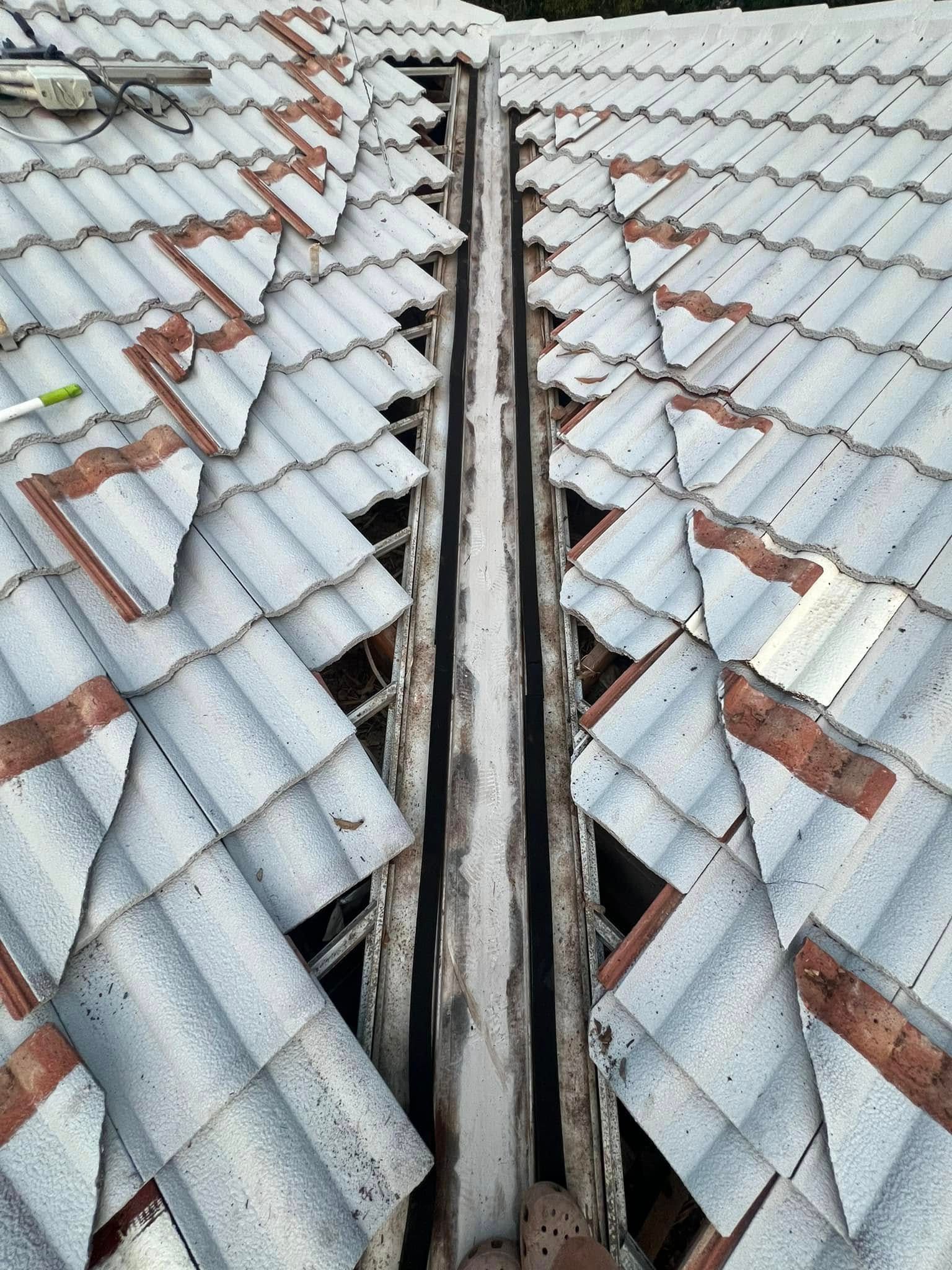 View From Above of a Roof Valley With Missing and Broken Tiles — SEQ Roofing & Painting in Labrador, QLD