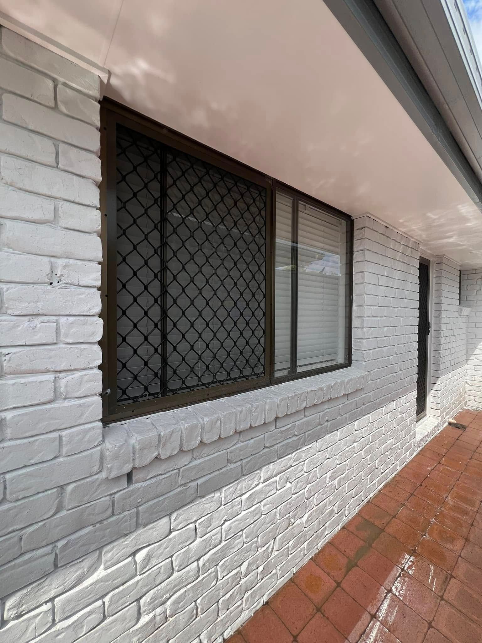 White Brick Building With Brown Framed Windows — SEQ Roofing & Painting in Nerang, QLD