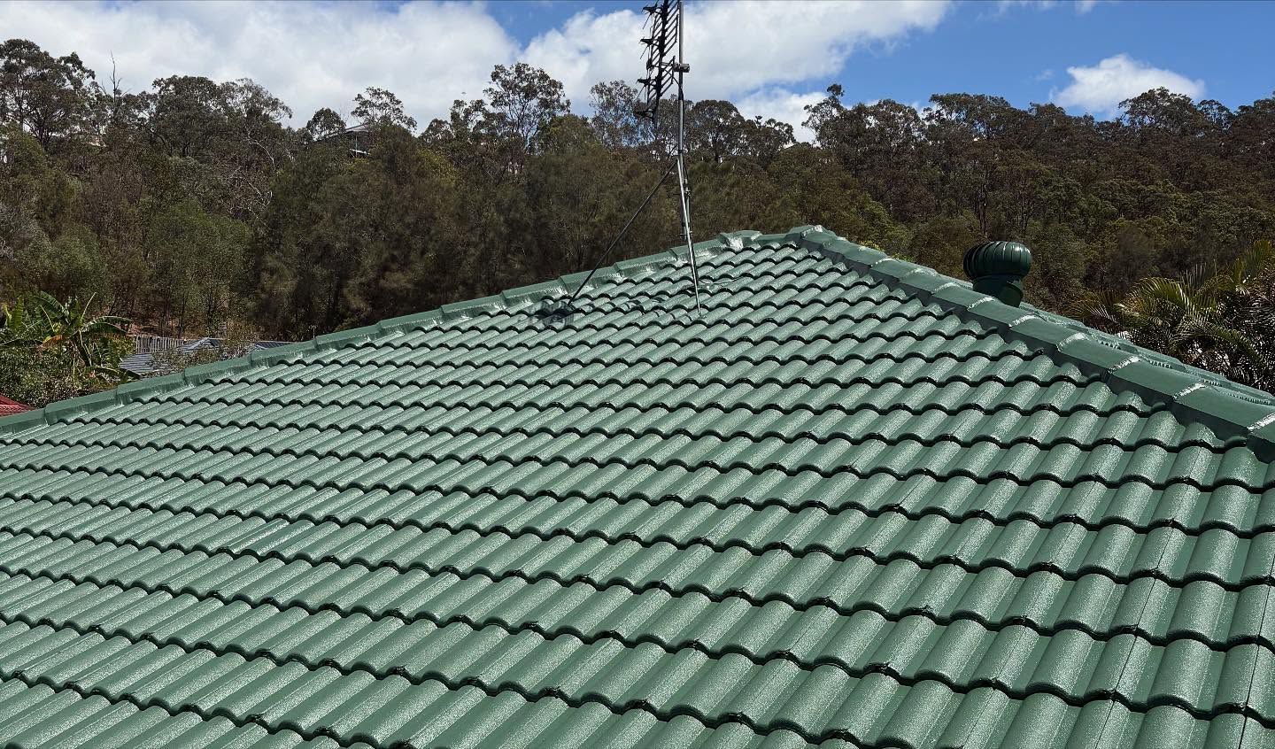 Green Tiled Roof With a Mountain Backdrop and Blue Sky — SEQ Roofing & Painting in Nerang, QLD