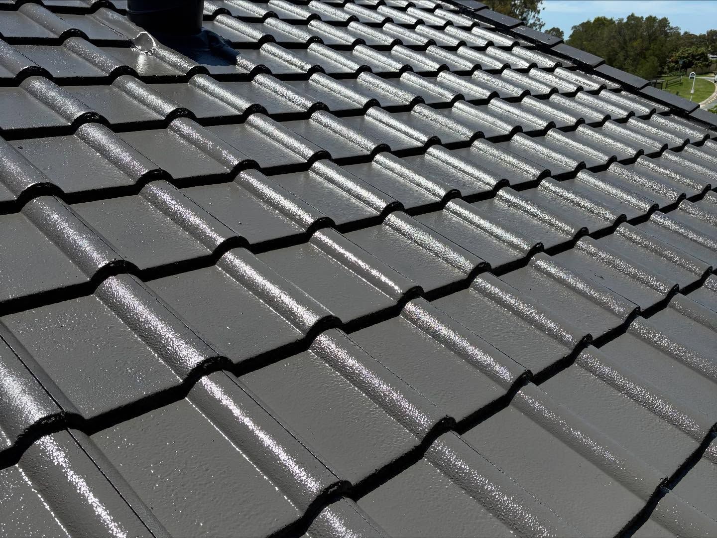 Dark Gray Tiled Roof, Shiny and Angled, With a Black Chimney — SEQ Roofing & Painting in Surfers Paradise, QLD