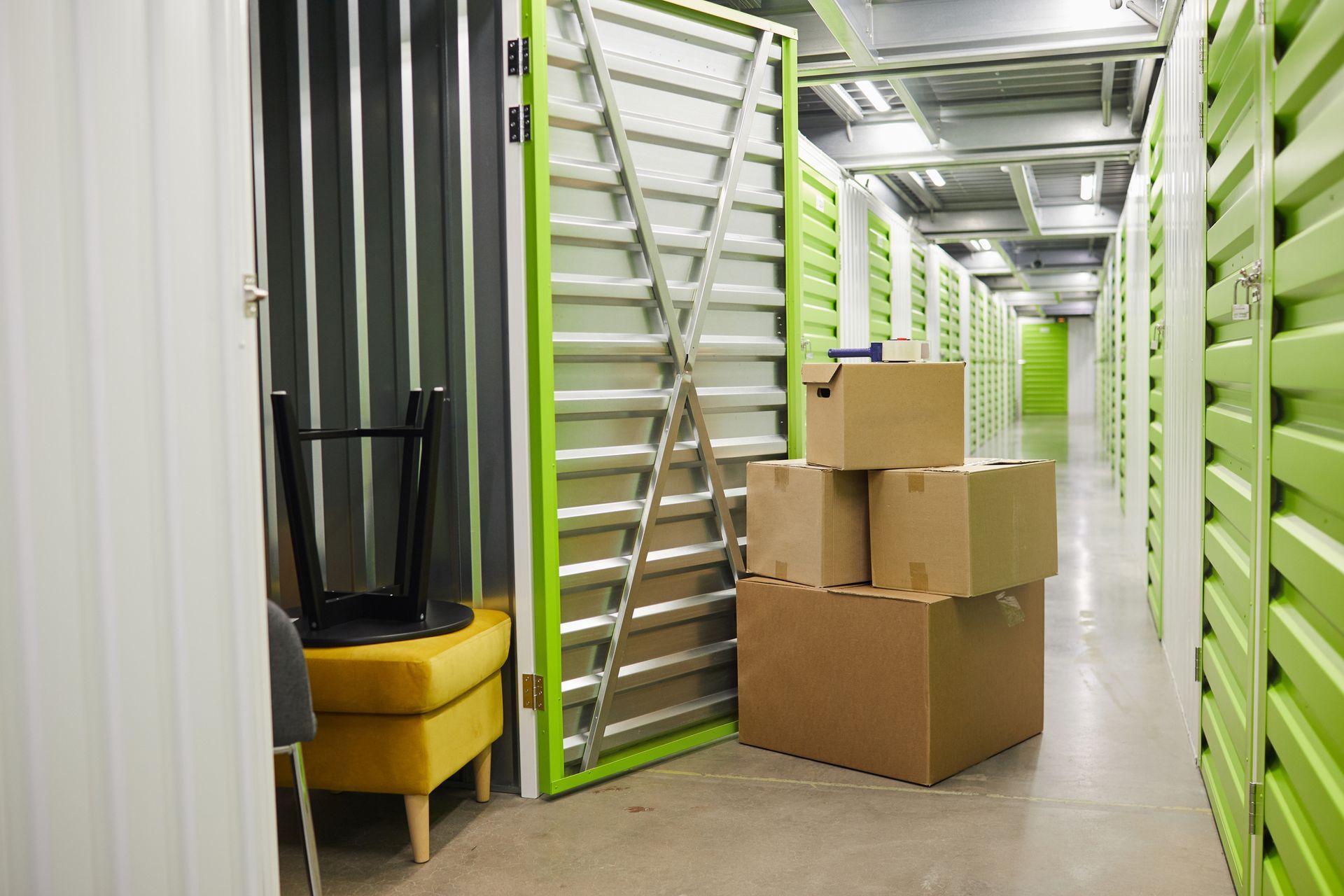 A stack of cardboard boxes in a room with green walls