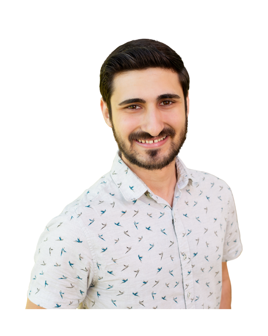 Man with dark hair and beard, smiling, wearing a patterned white button-up shirt.