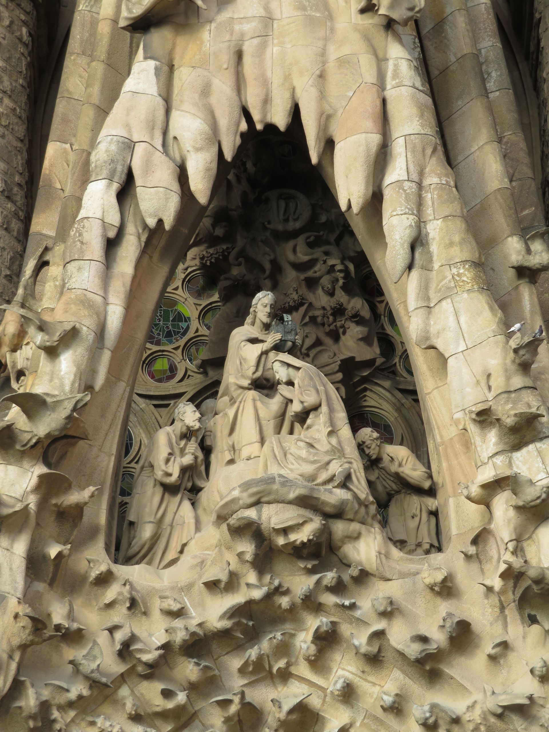 There is a wicker chair and a table on the beach.