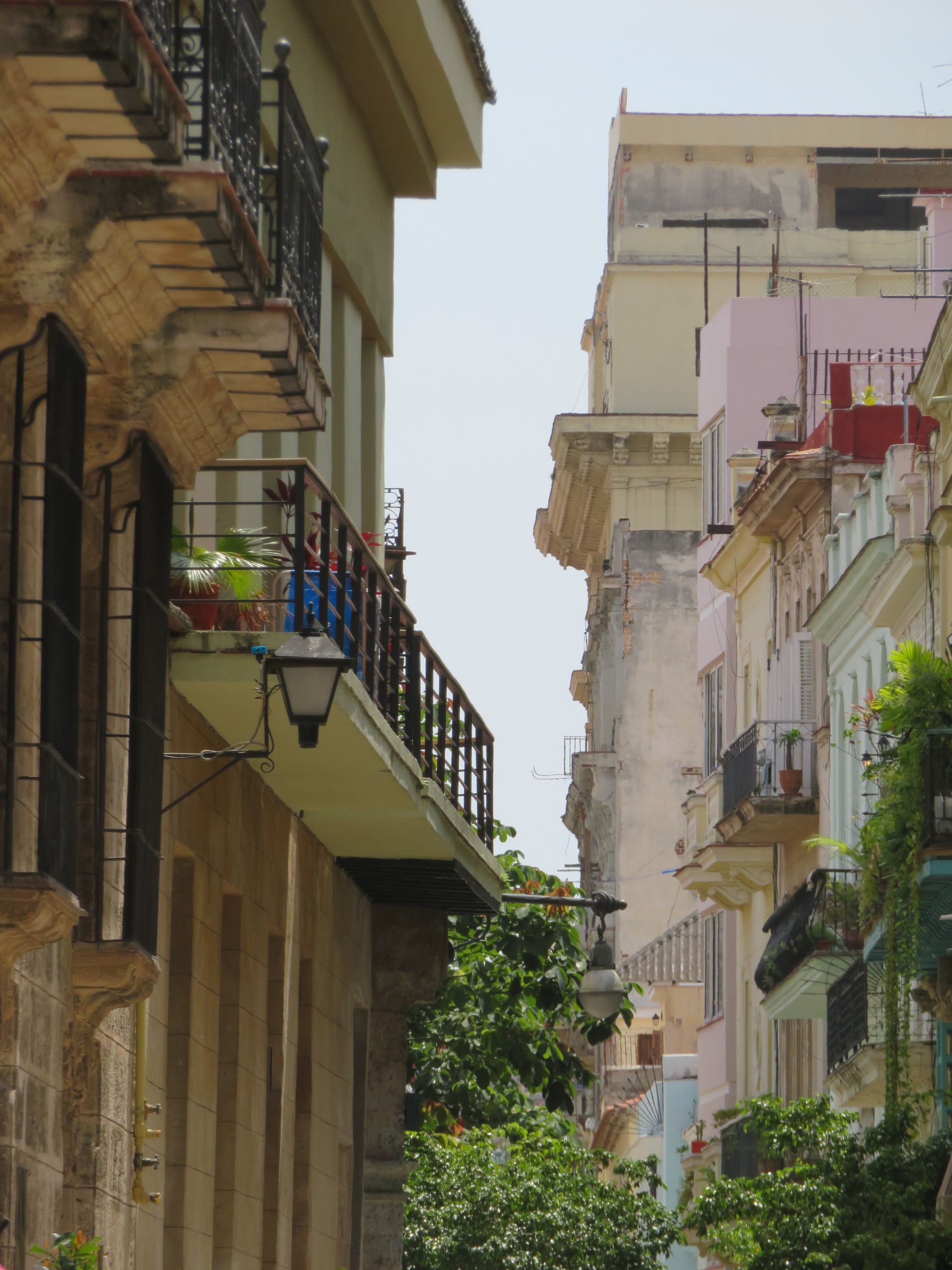 A man with a backpack is standing on top of a mountain.