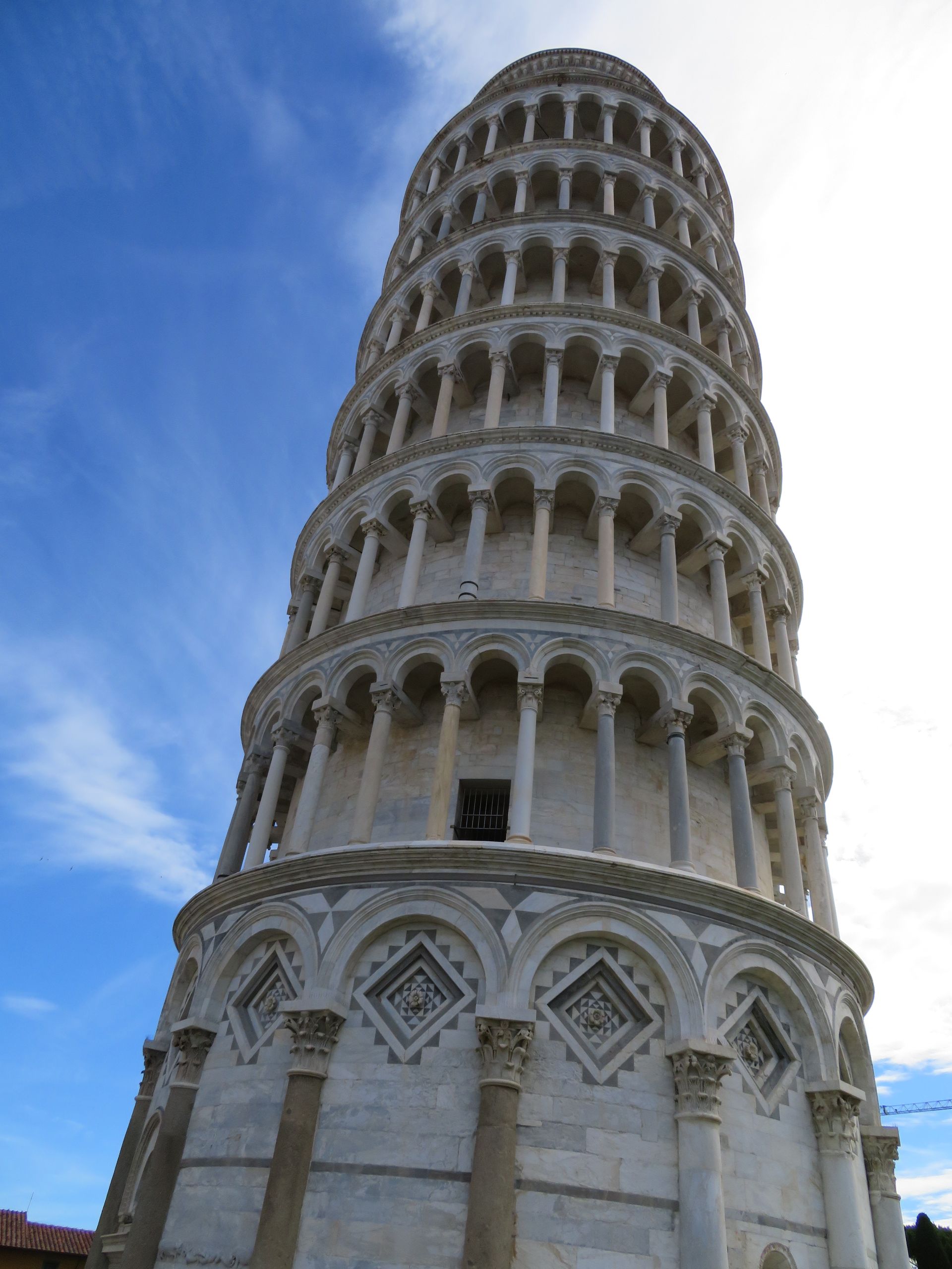A large passenger jet is parked on the tarmac at an airport at sunset.
