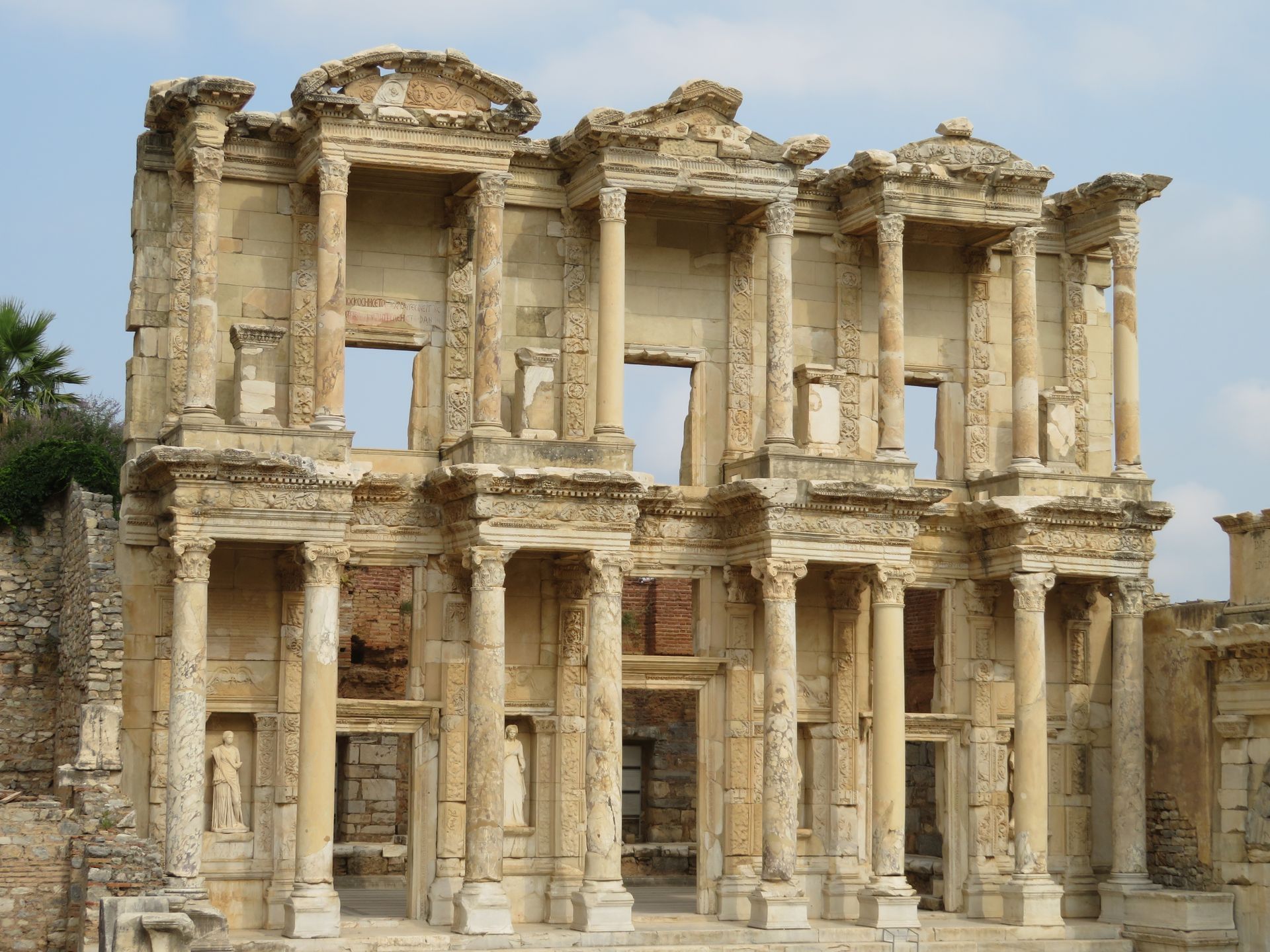 A row of palm trees against a blue sky