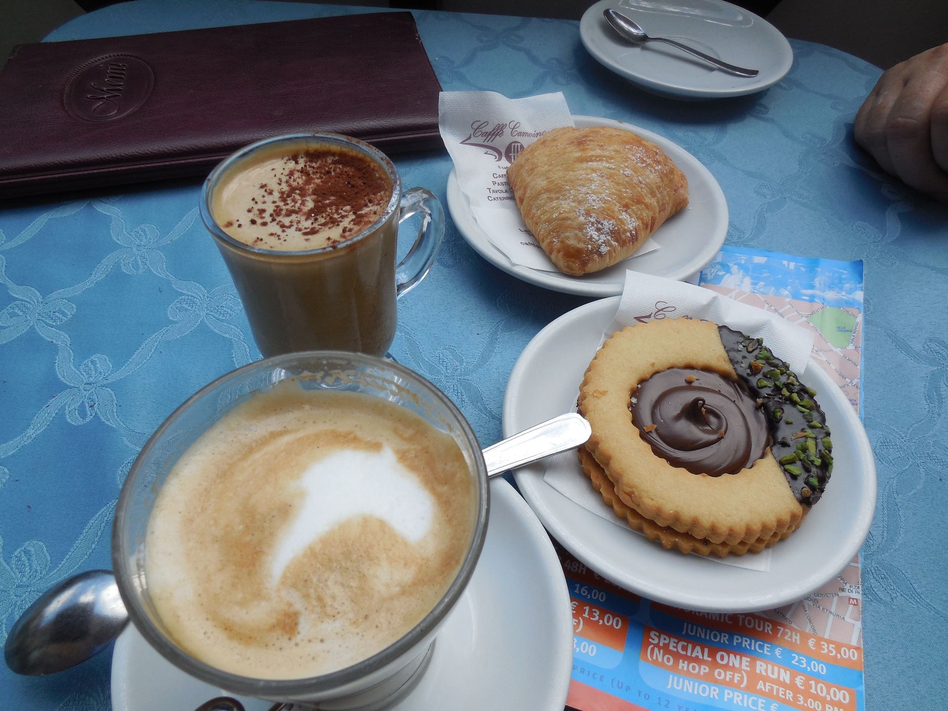 Two colorful parrots looking at each other with a blue sky in the background