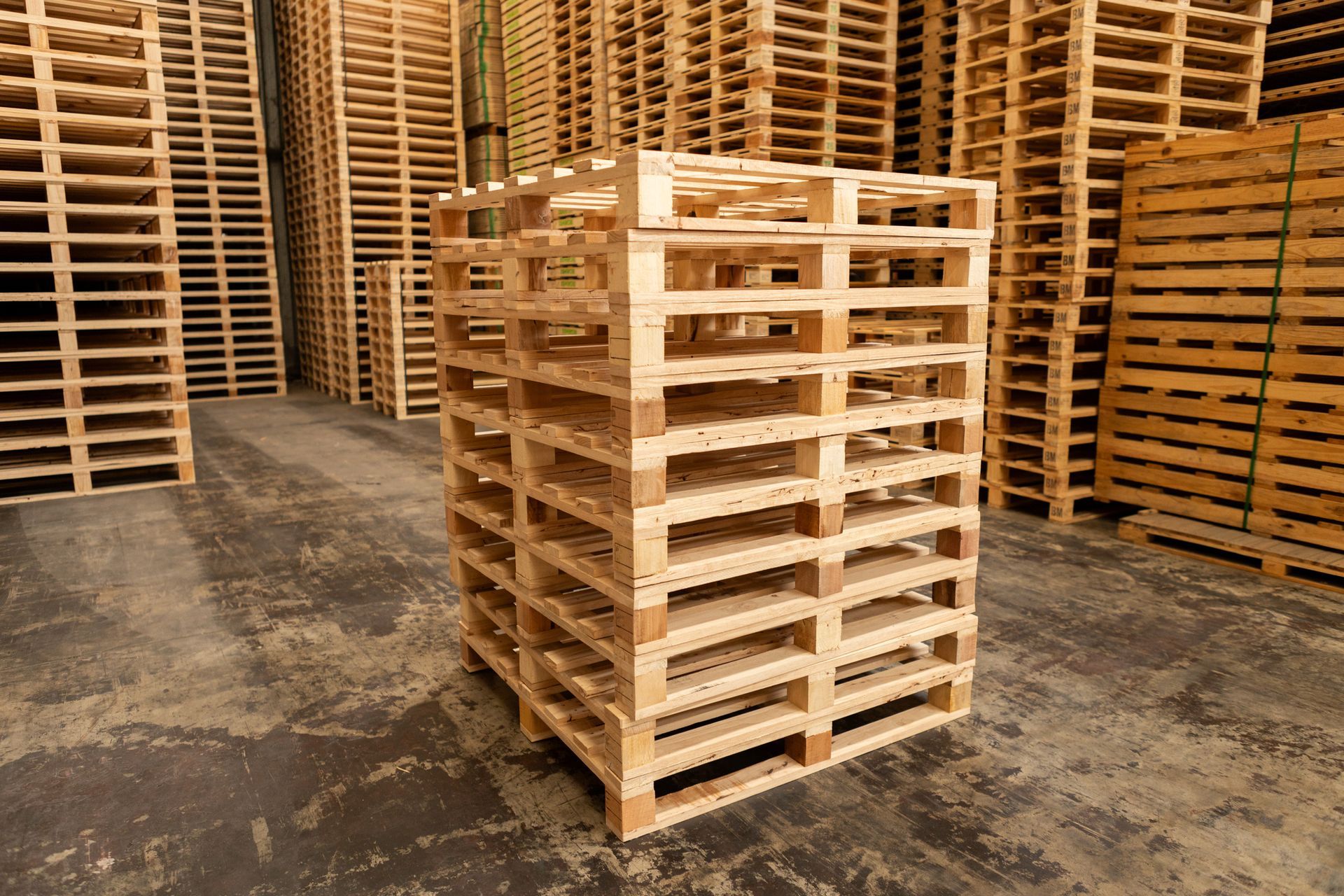 A stack of wooden pallets in a warehouse.
