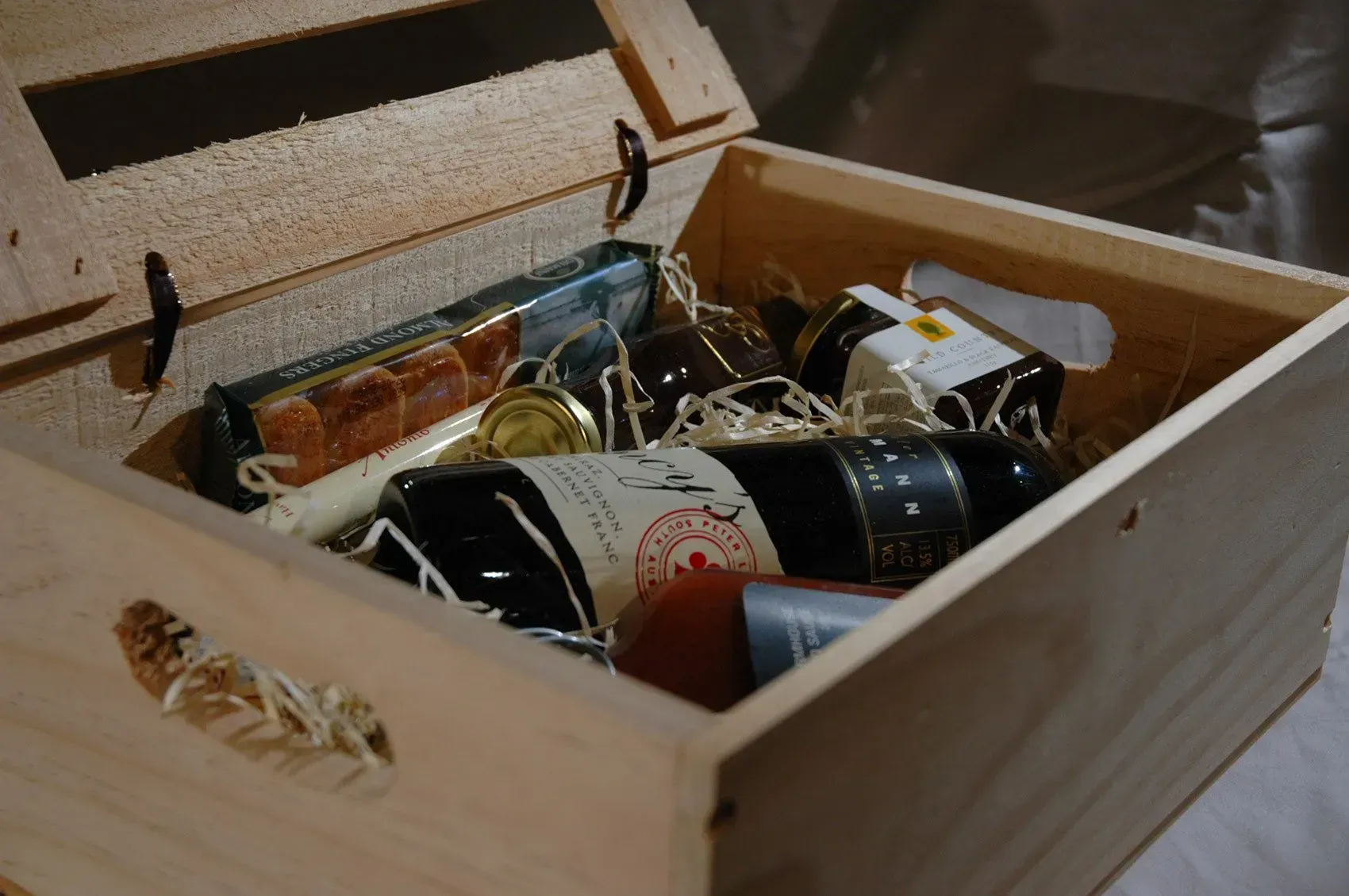 Two bottles of wine are in a wooden box.