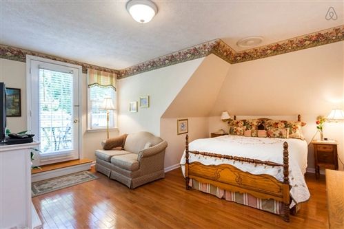 A bedroom with a king size bed and a couch