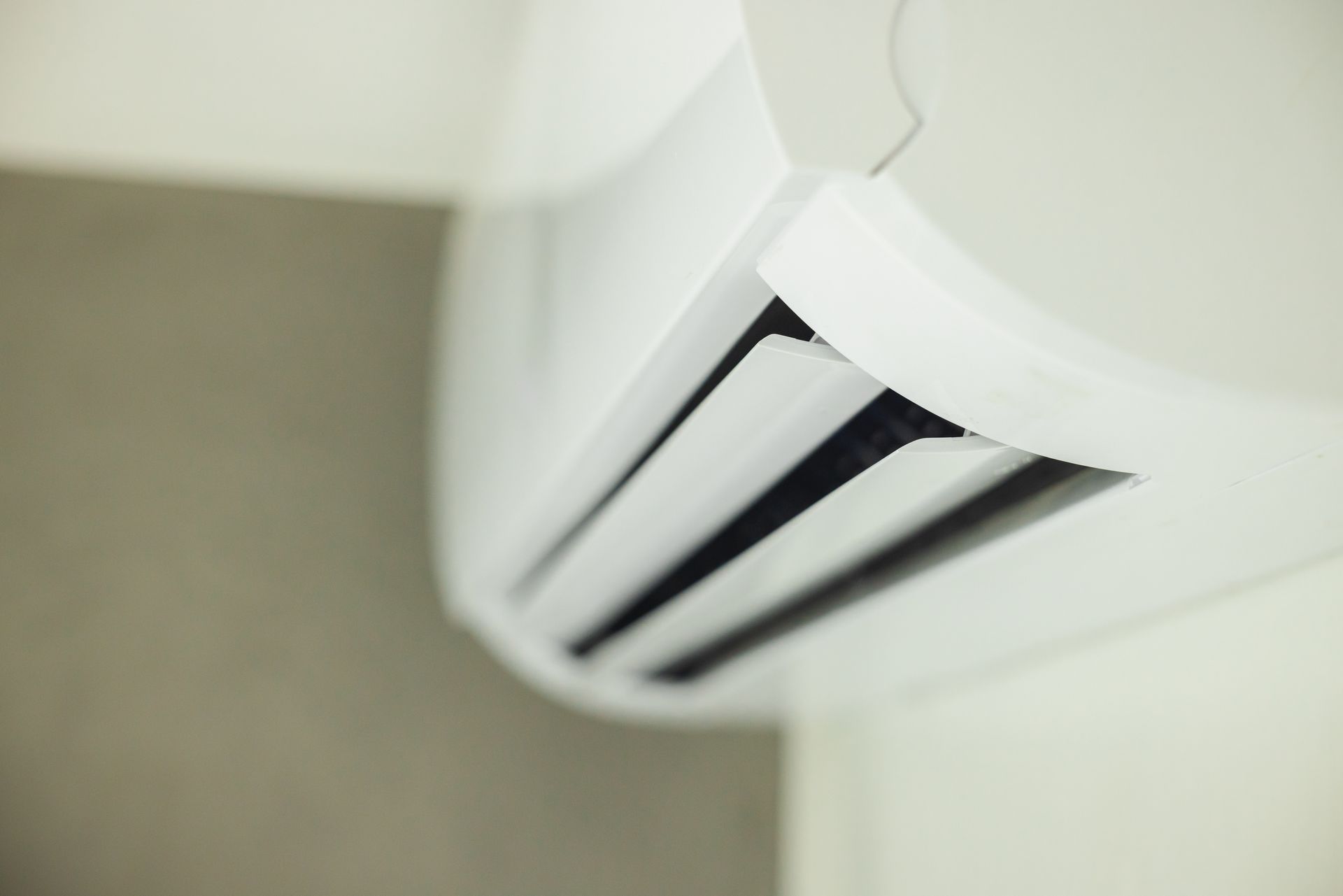 White air conditioning unit mounted on a wall.