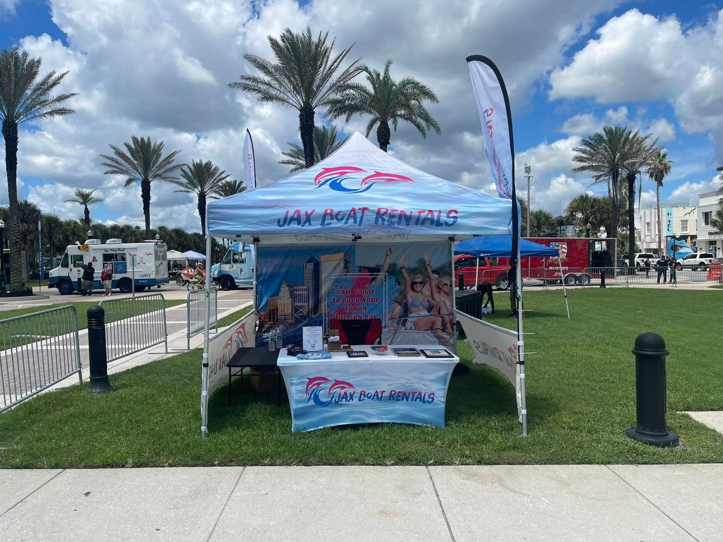 A tent with a table underneath it is in a park.