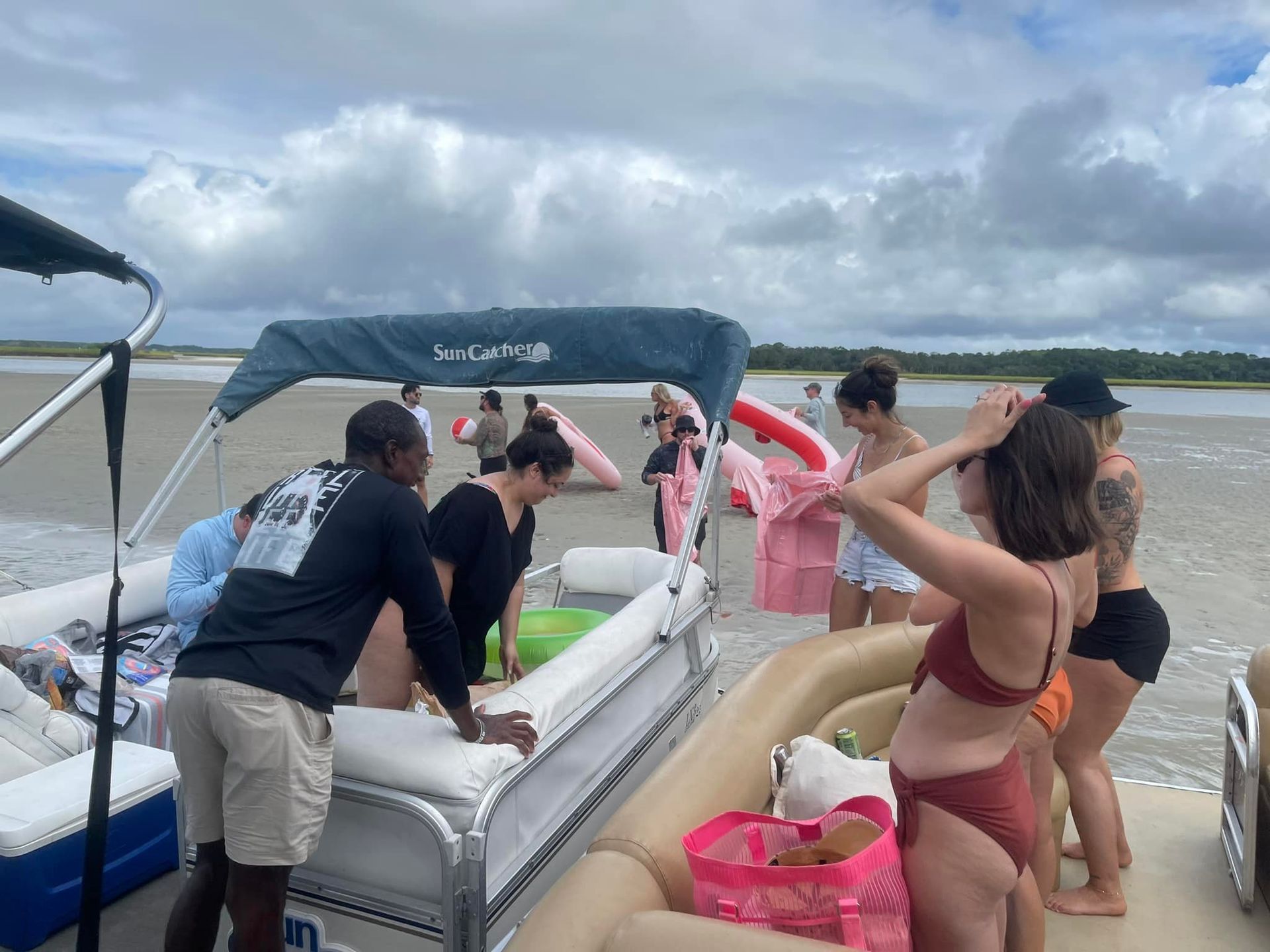A group of people are standing on a boat in the water.