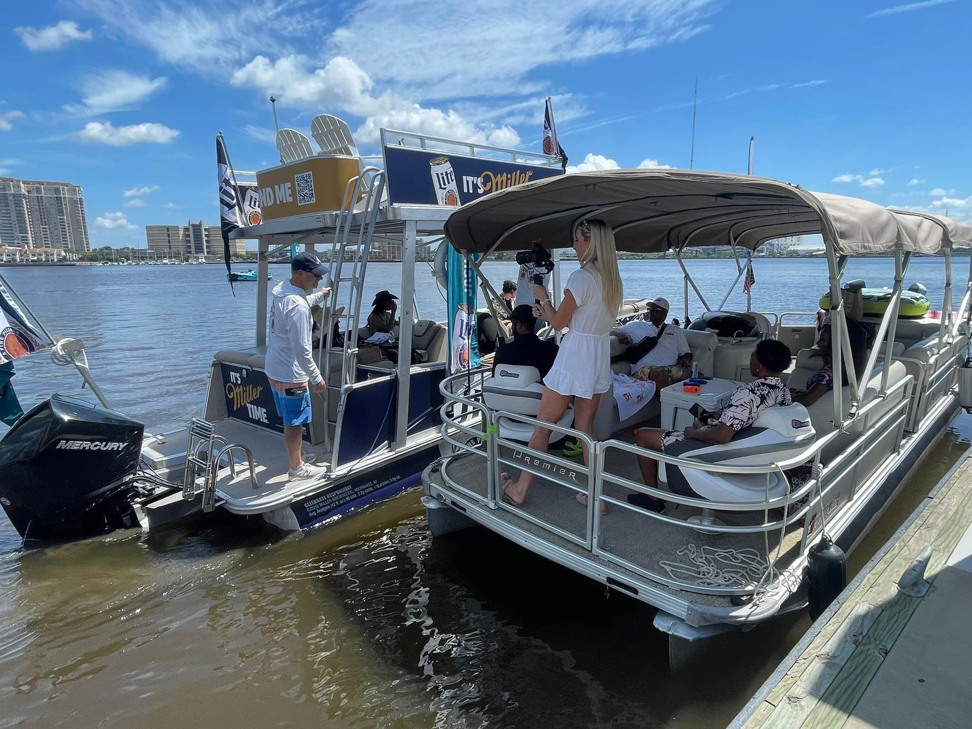 A group of people are sitting on a pontoon boat in the water.