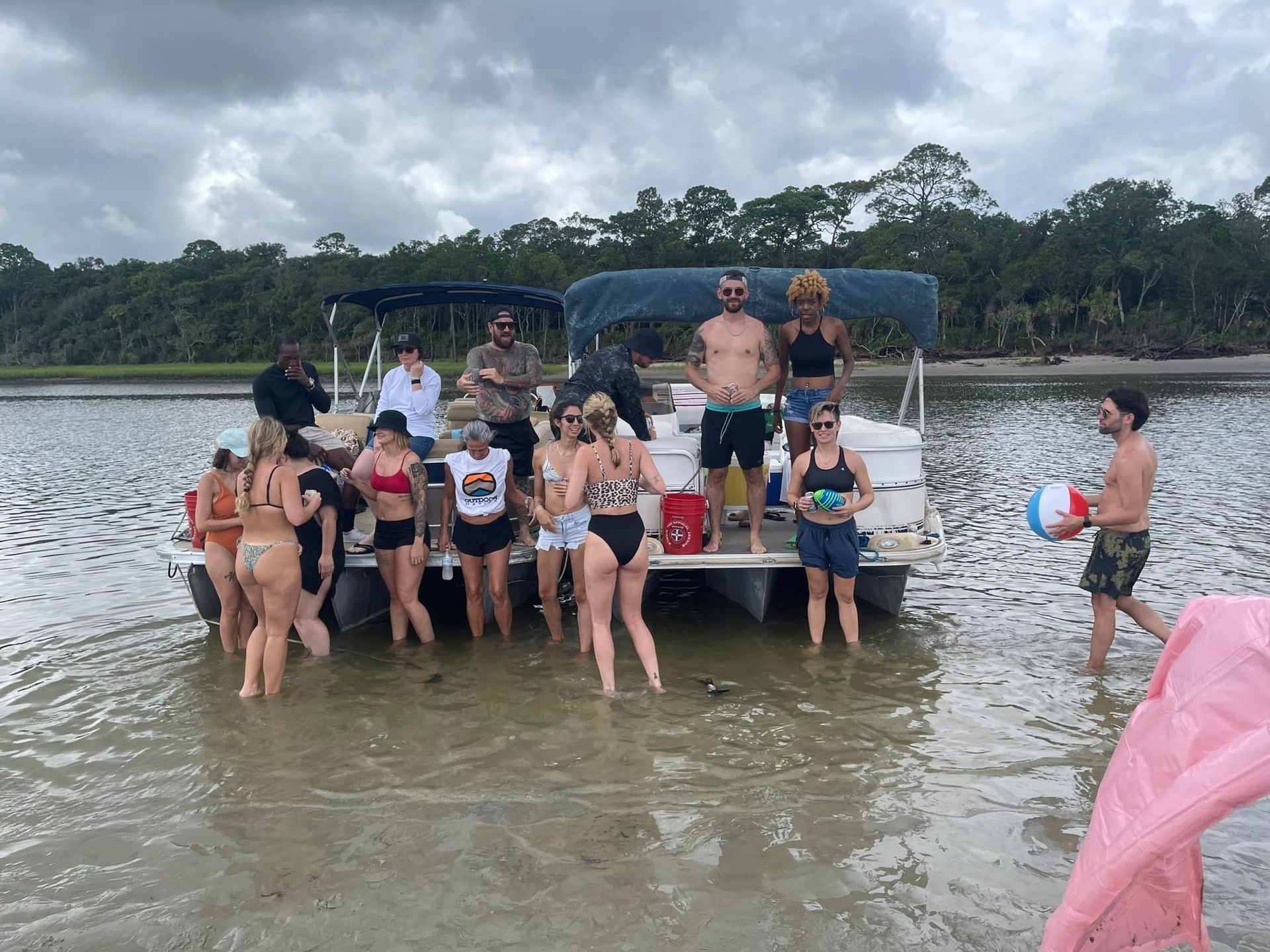 A group of people are standing on a boat in the water.