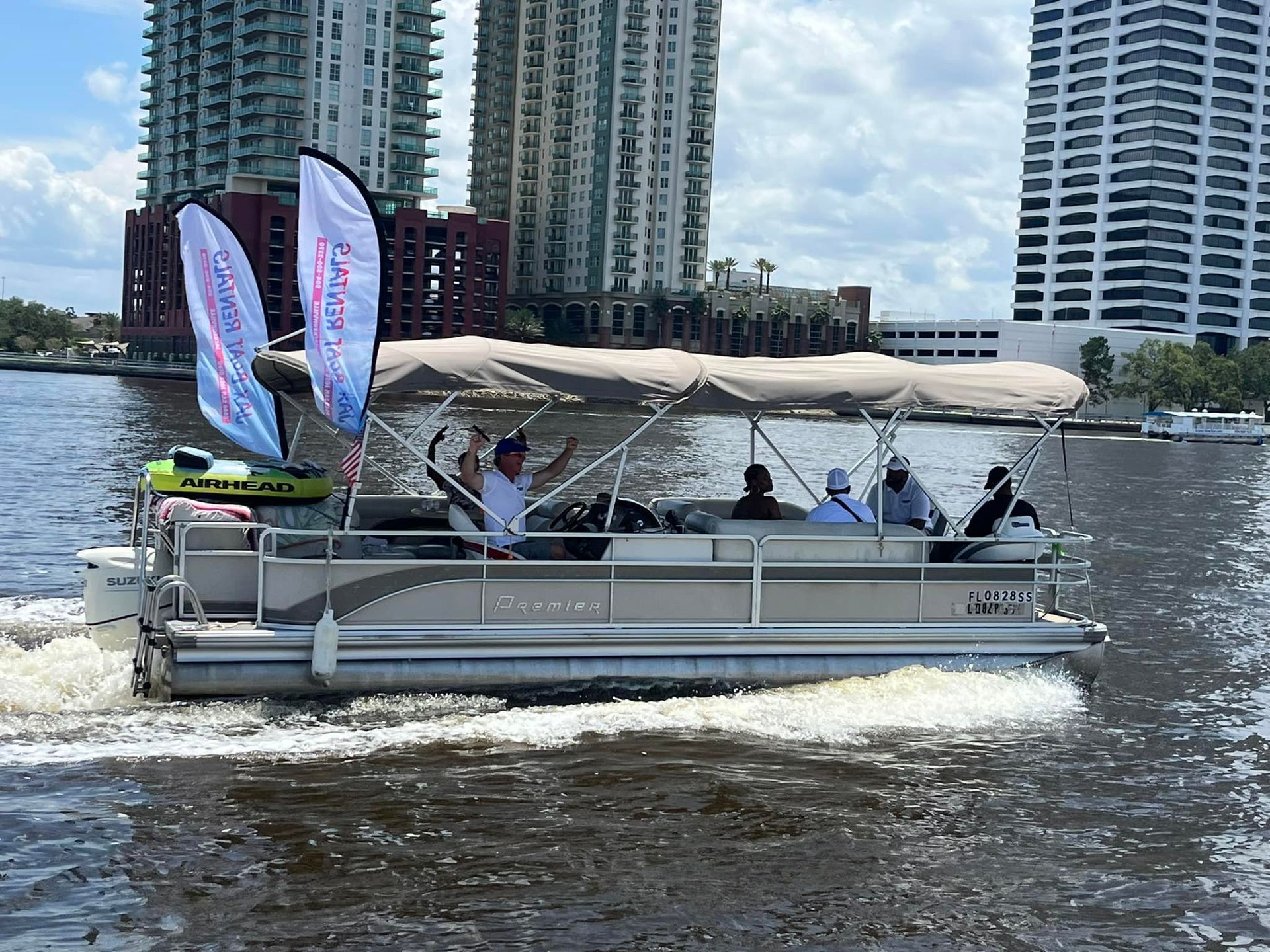 A group of women are sitting on a boat in the water.