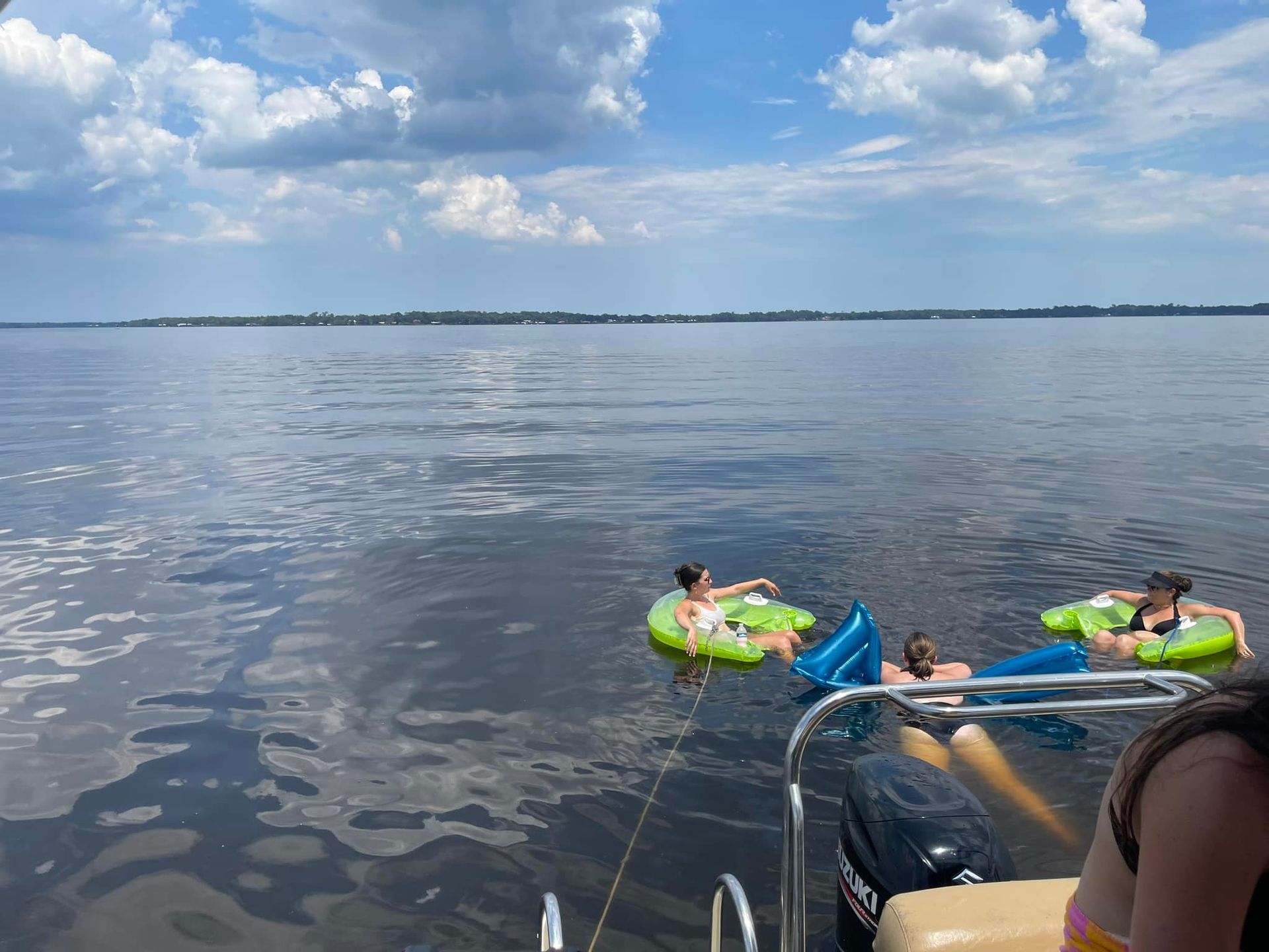 A group of people are floating on rafts in the water.