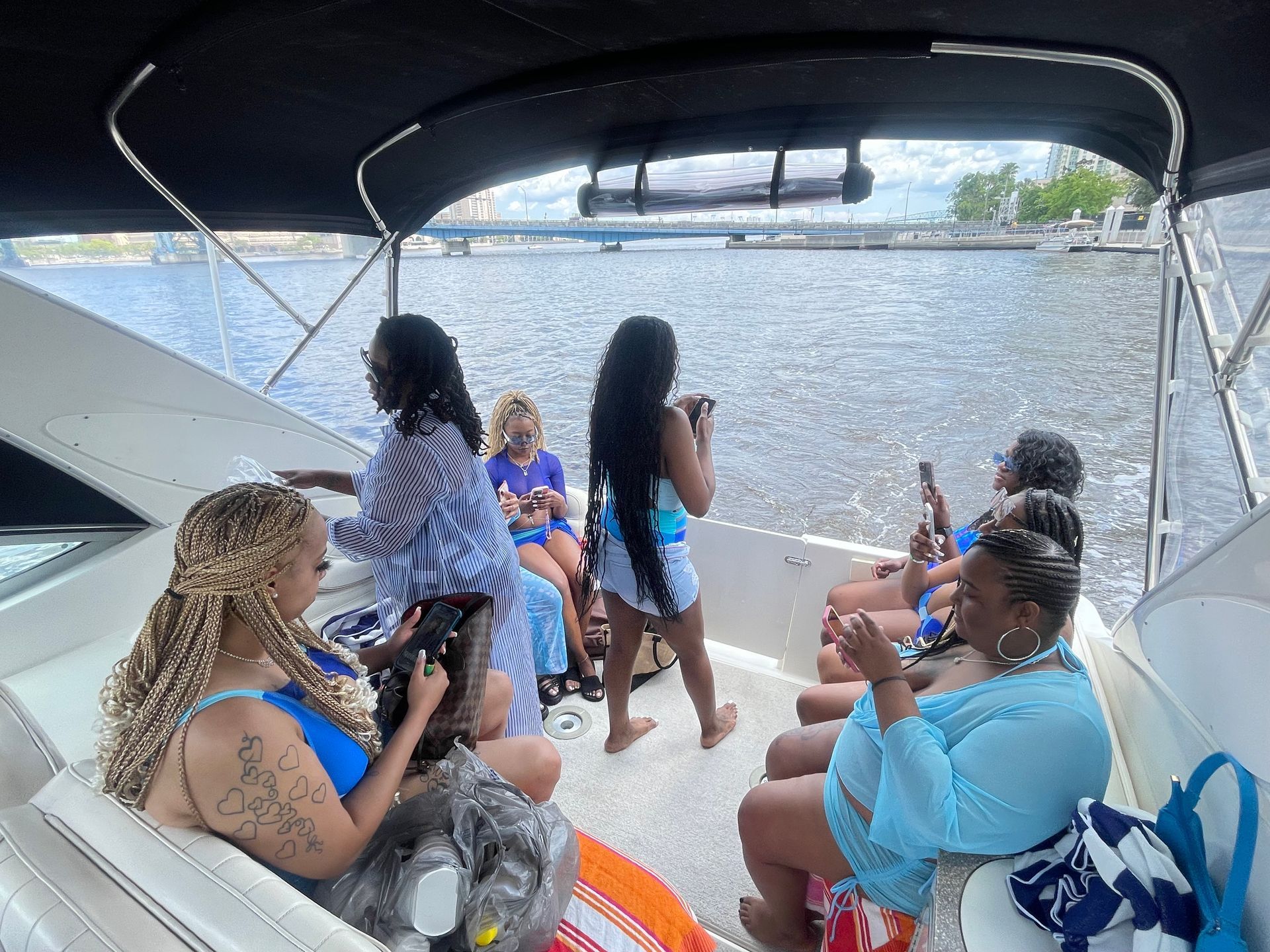 A group of women are sitting on a boat in the water.