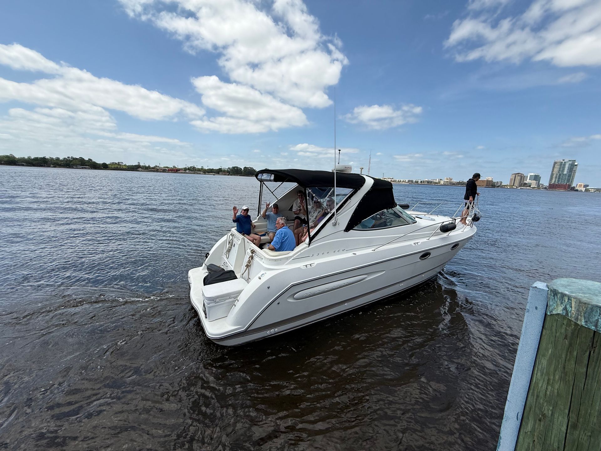 A white boat is floating on top of a body of water.