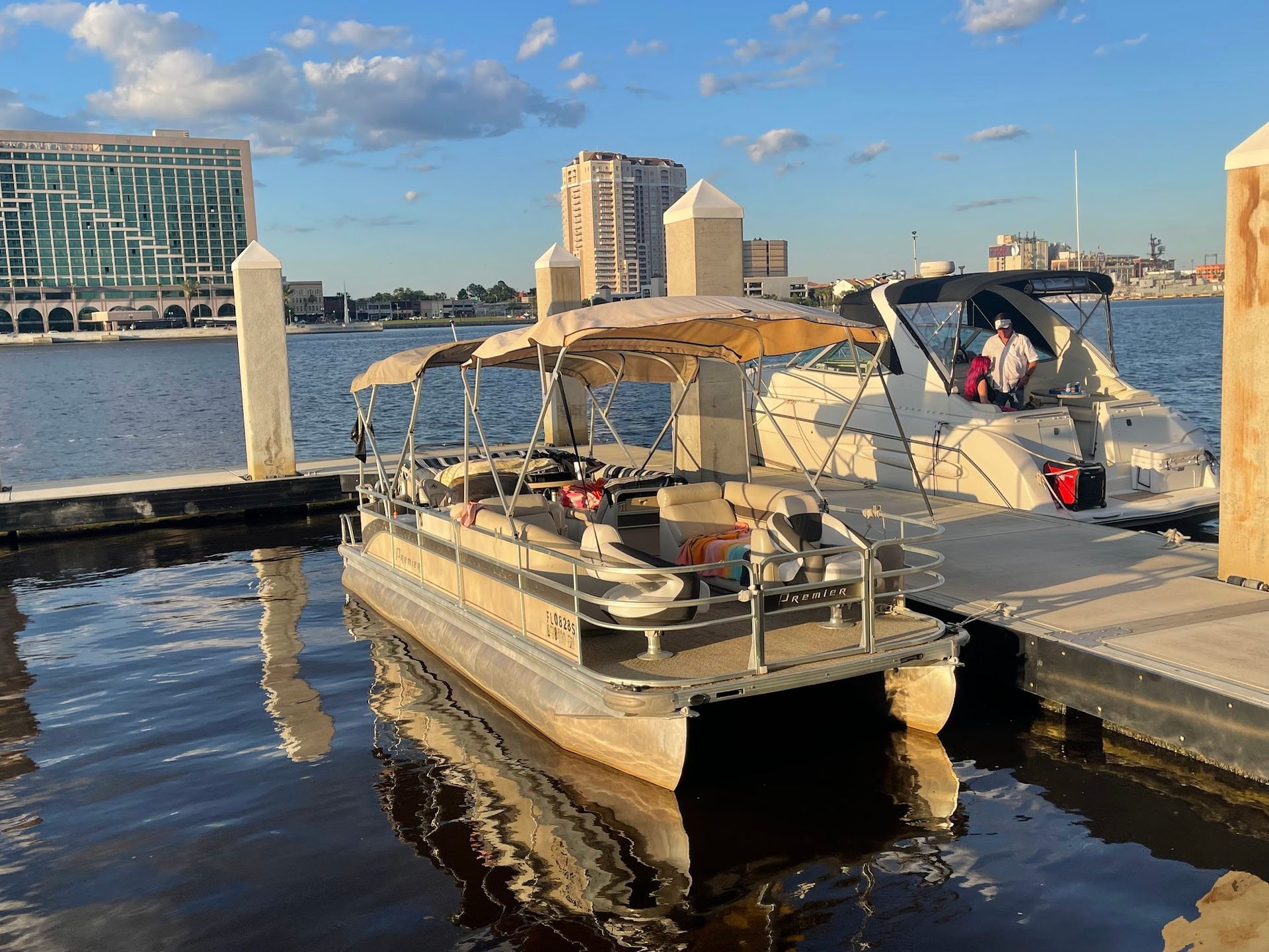 A pontoon boat is docked at a dock in the water