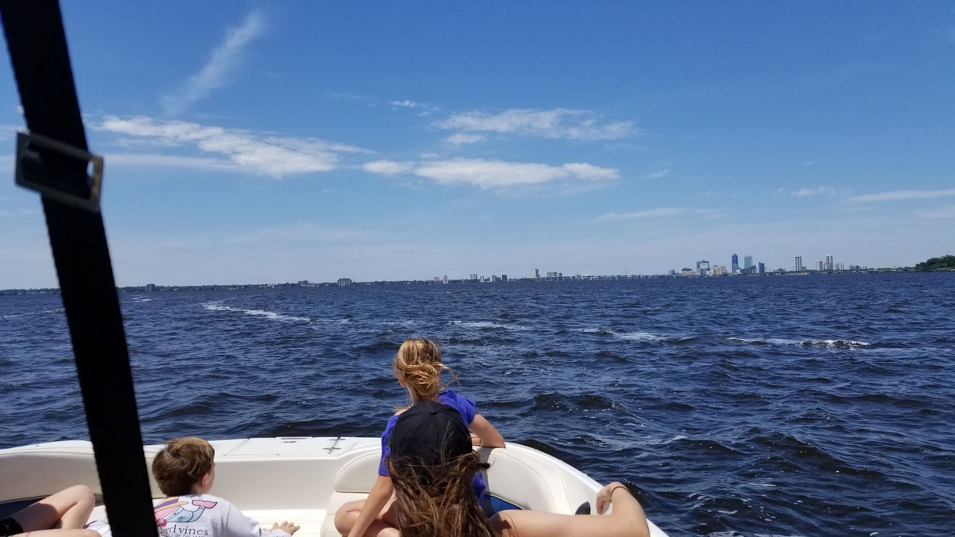 A group of people are sitting on a boat in the water.