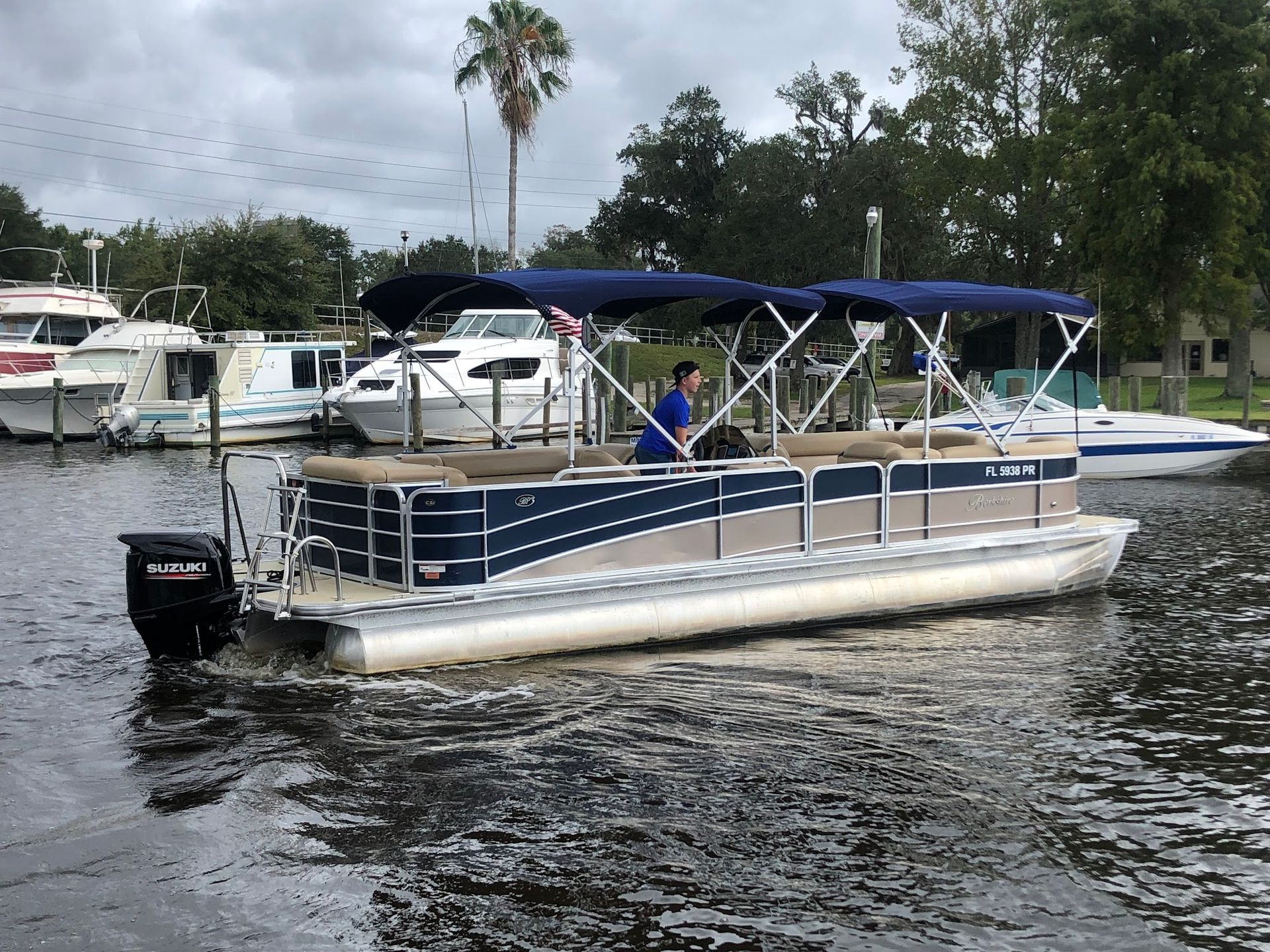 A pontoon boat is floating on top of a body of water.
