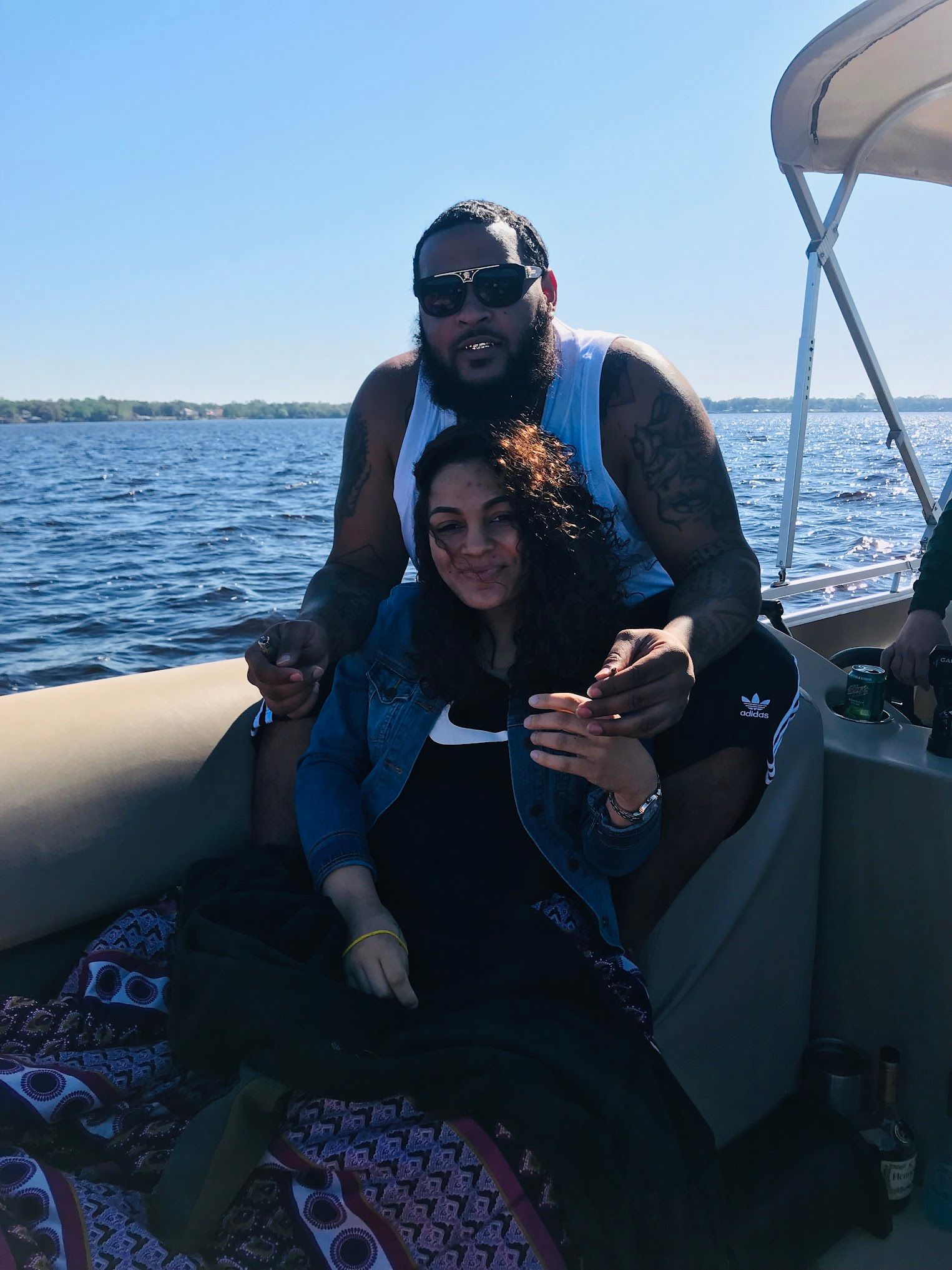 A man and a woman are sitting on a boat in the water.
