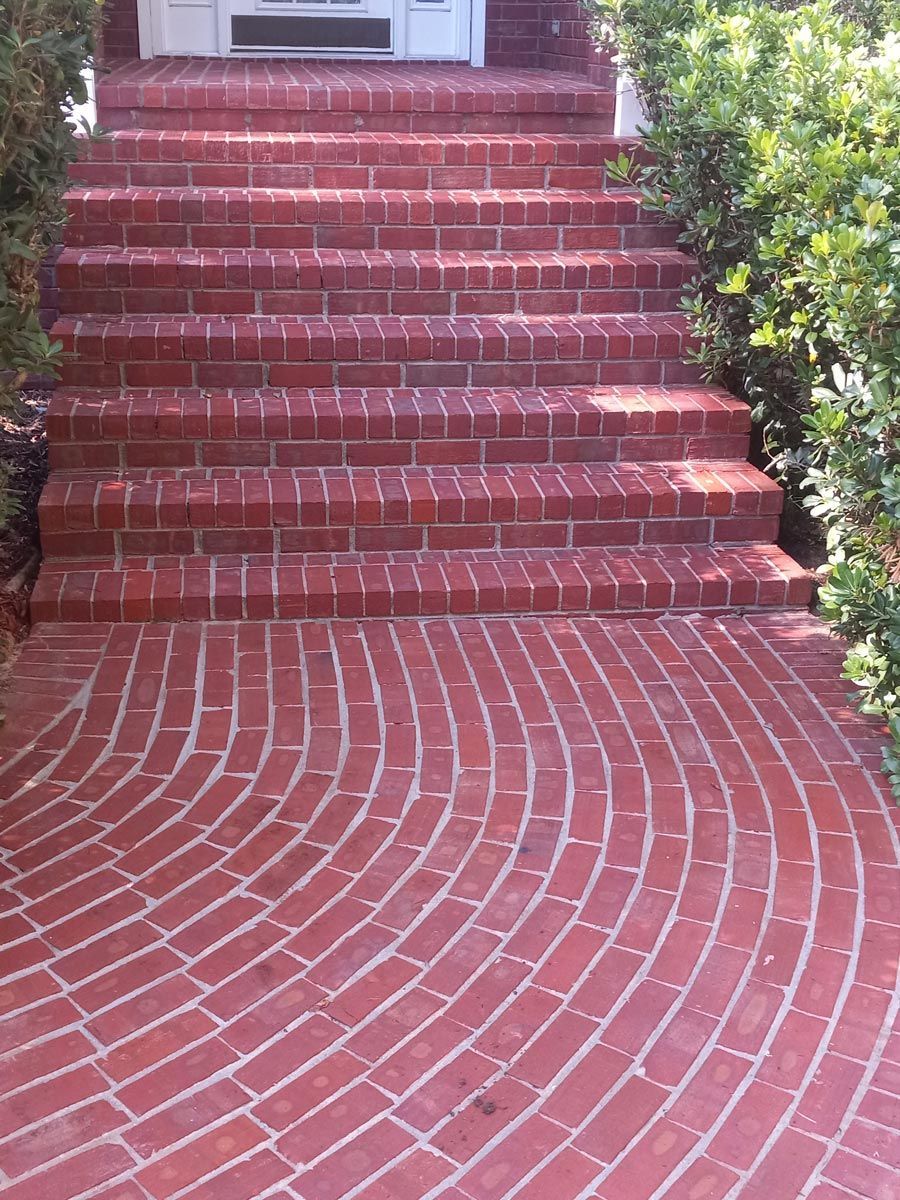 A set of brick stairs leading up to a door