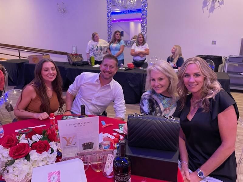 A group of people are sitting at a table in a room.