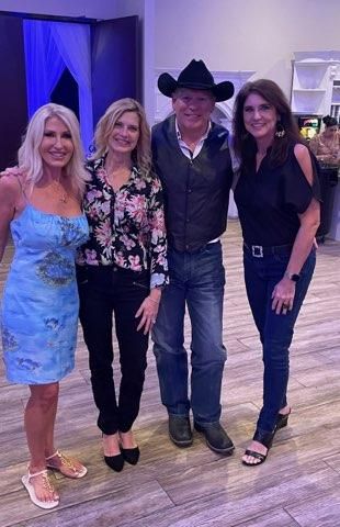 A group of people are posing for a picture together in a room.