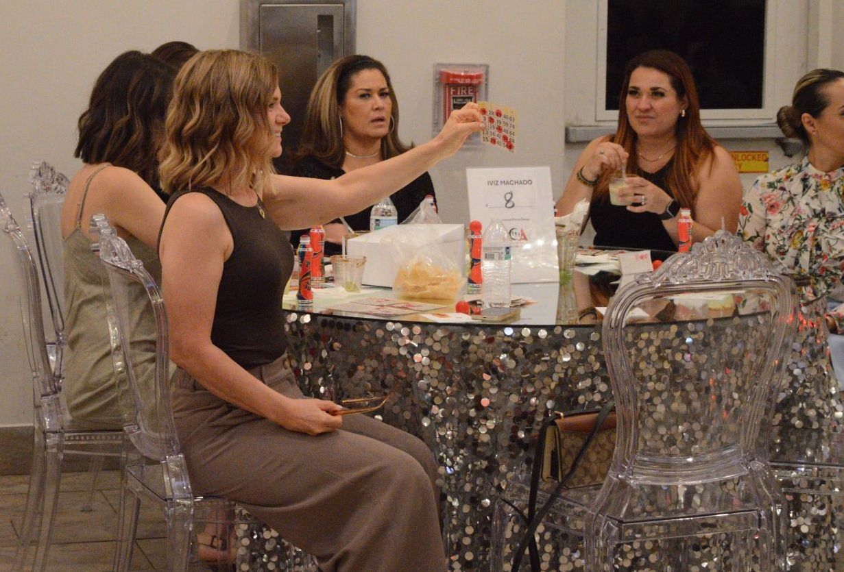 A group of women are sitting around a table.