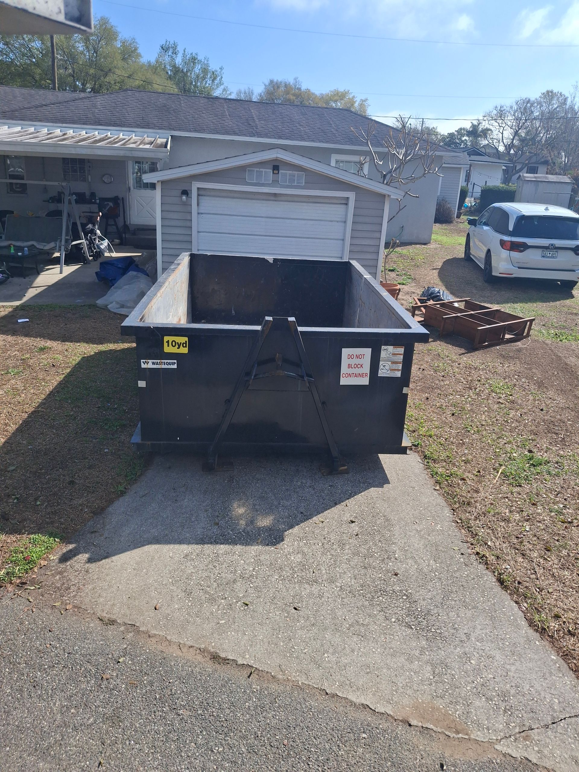 10‑yard dumpster used for a garage cleanout at a home in Lakeland, Florida.