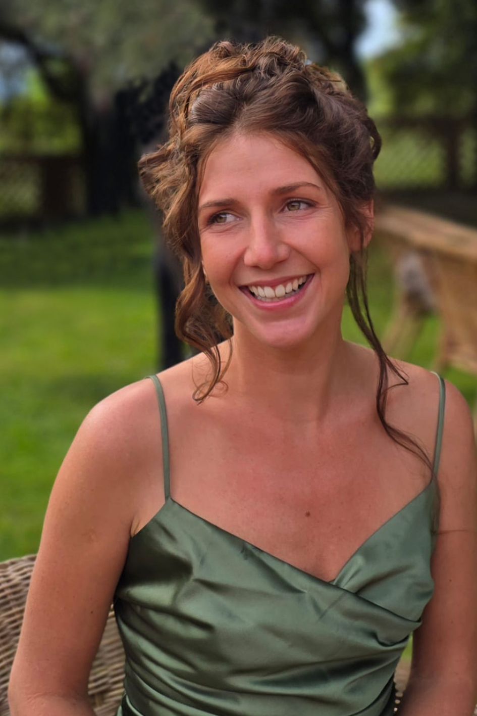 A woman with long dark hair is smiling for the camera.