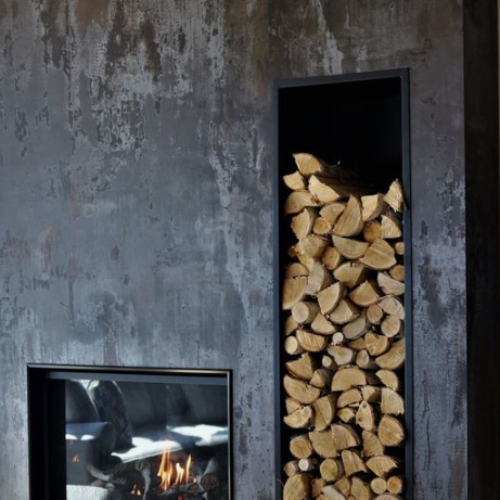 A fireplace with a stack of logs next to it