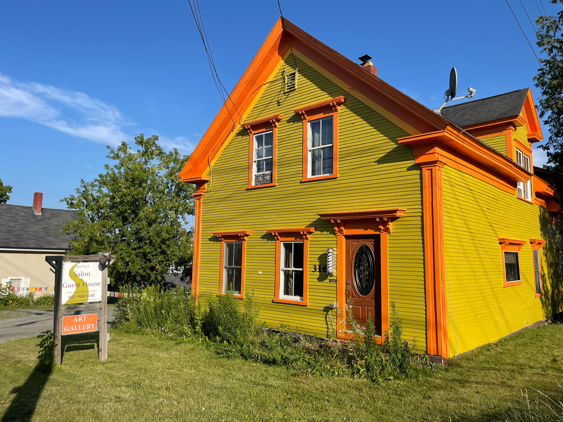 A yellow house with orange trim in the Northeast Kingdom of Vermont
