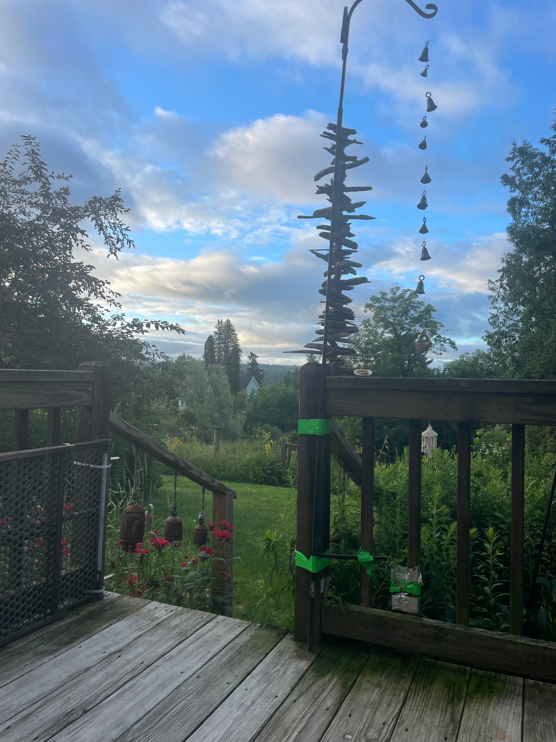 A wooden deck with a statue of a tree on it.