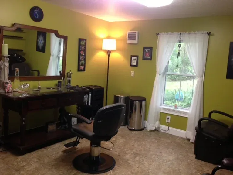A hair salon with a chair and a mirror