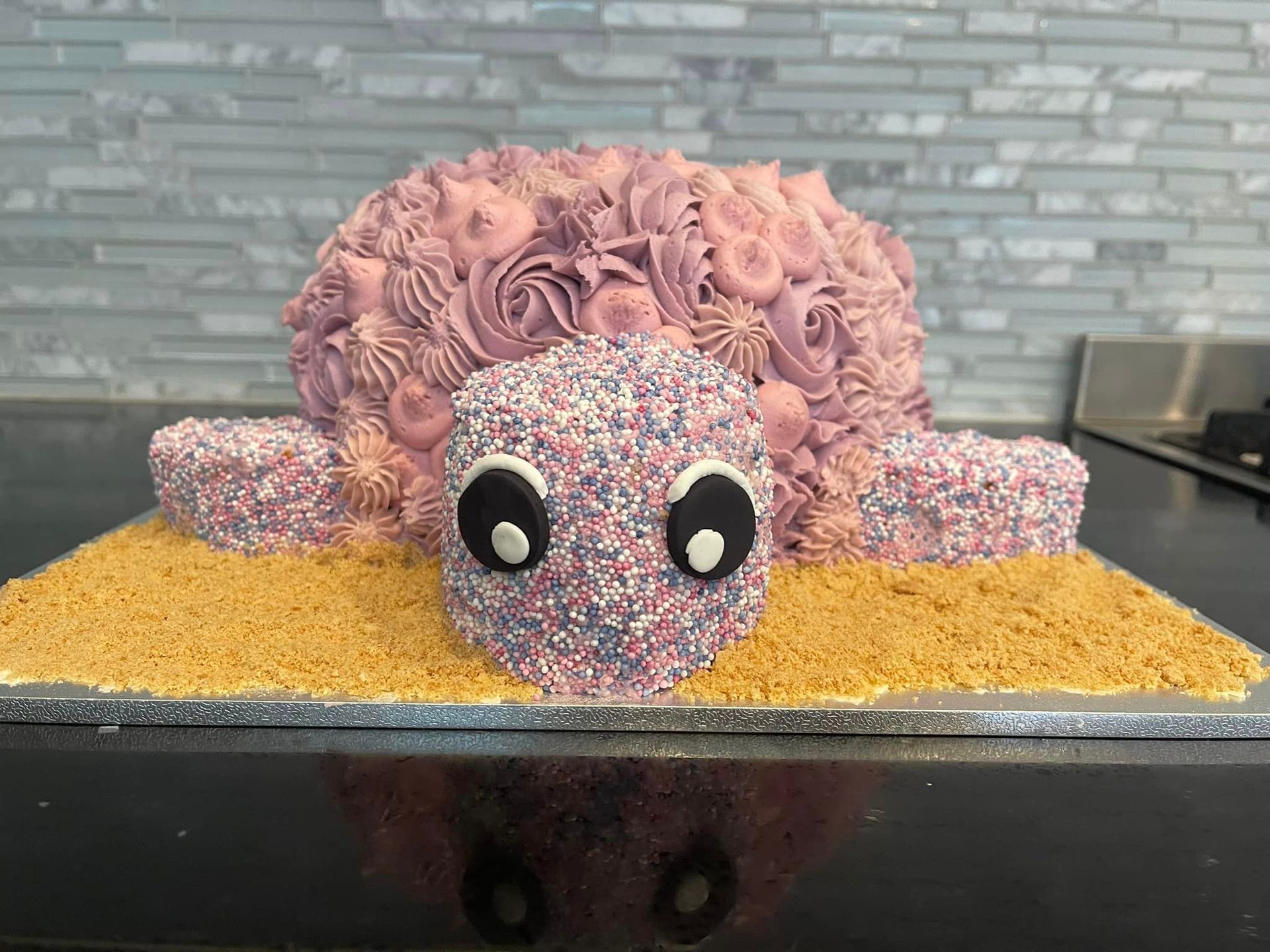 A cake in the shape of a sheep is sitting on a table.