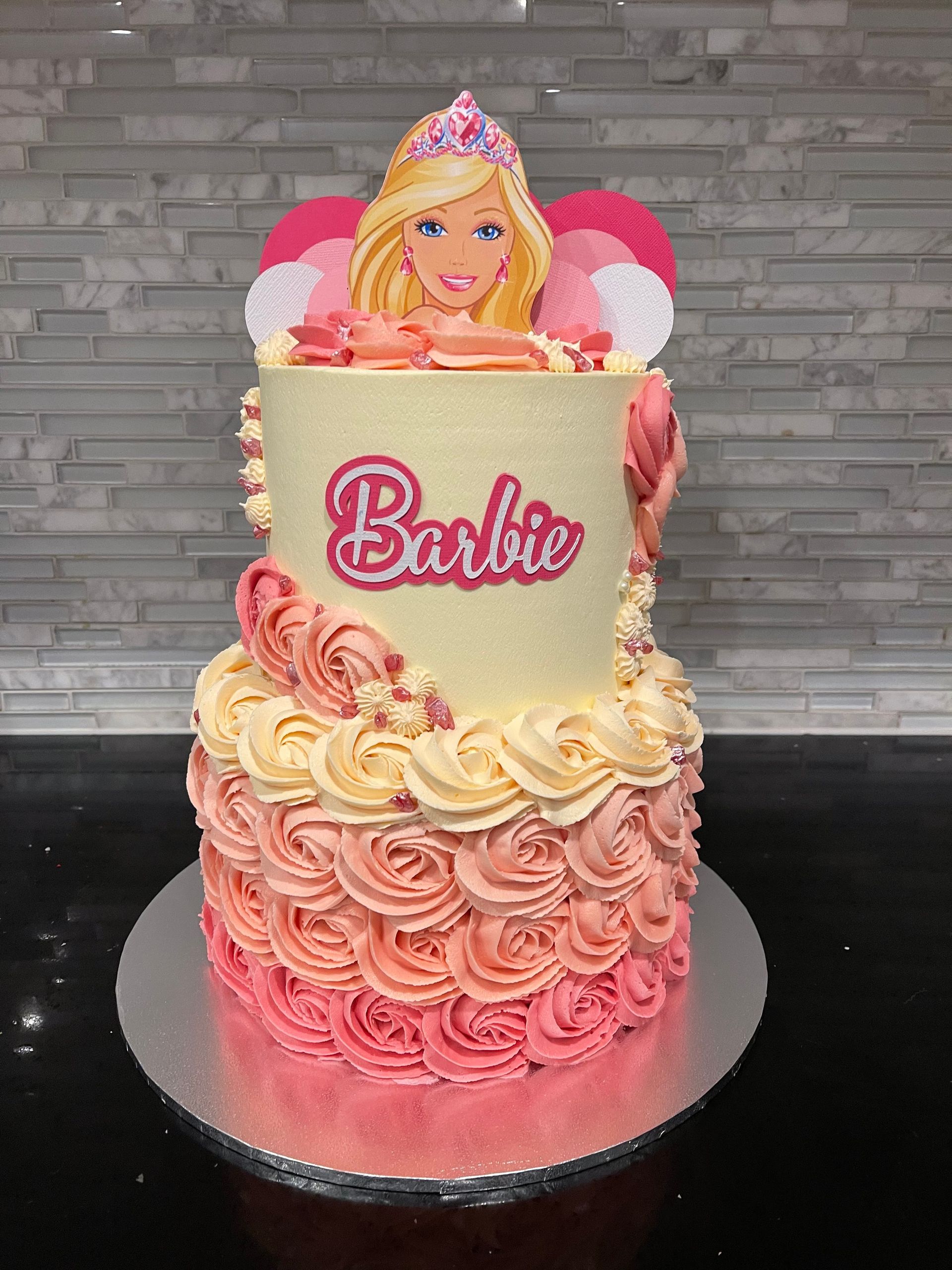 A cake with a picture of a barbie doll on top of it.