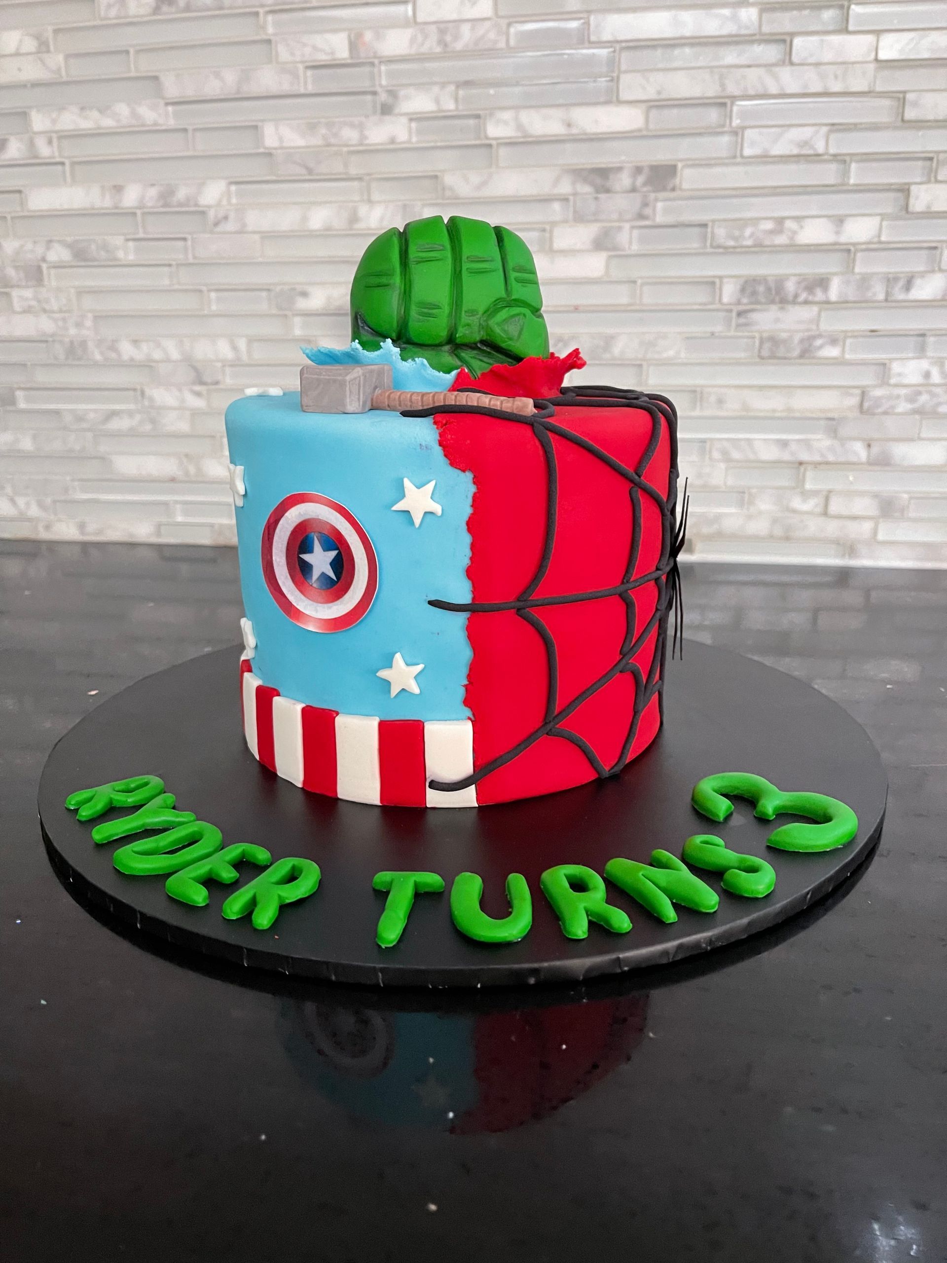 A birthday cake with captain america and hulk on it