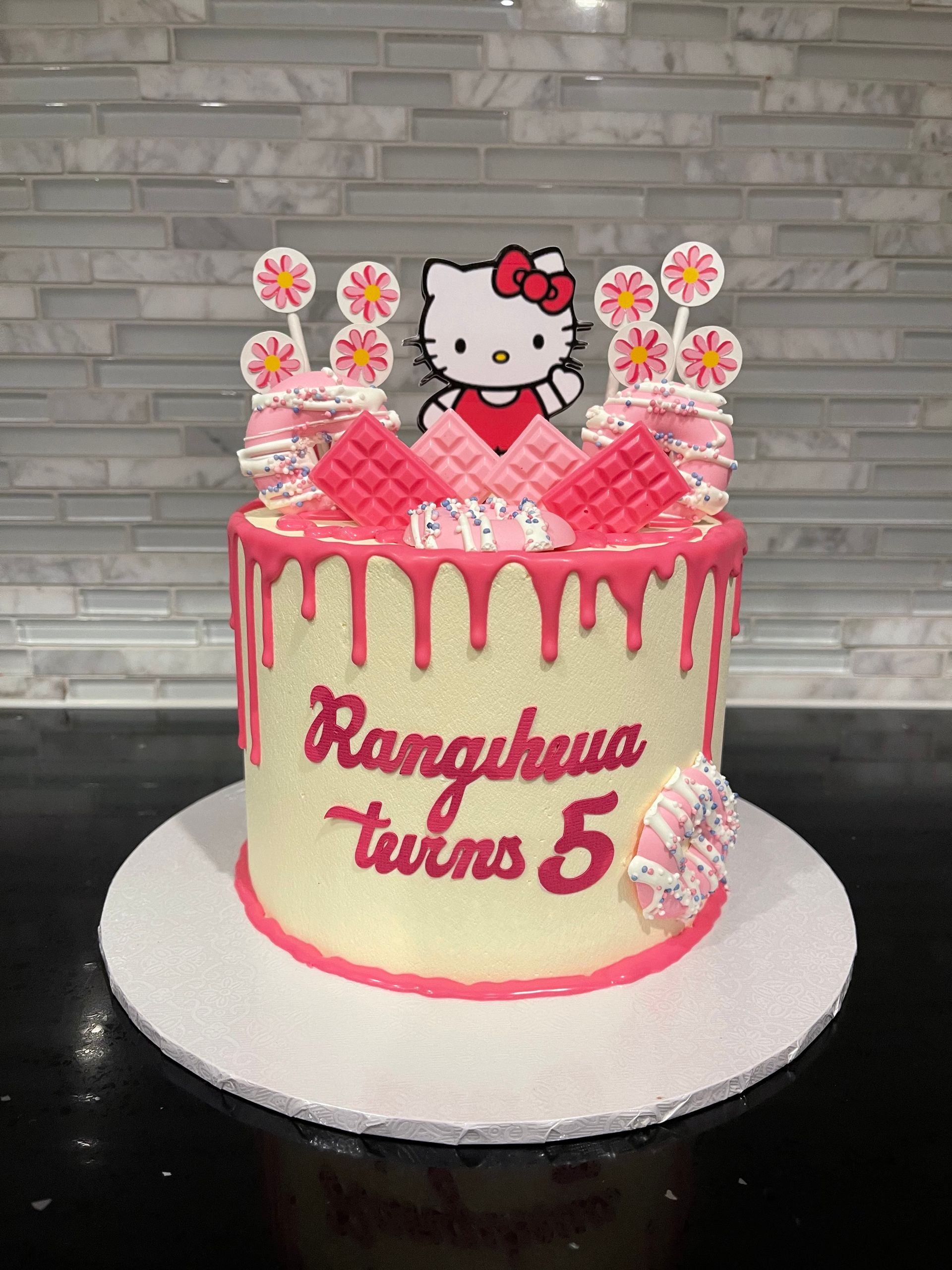 A hello kitty cake for a girl 's 5th birthday