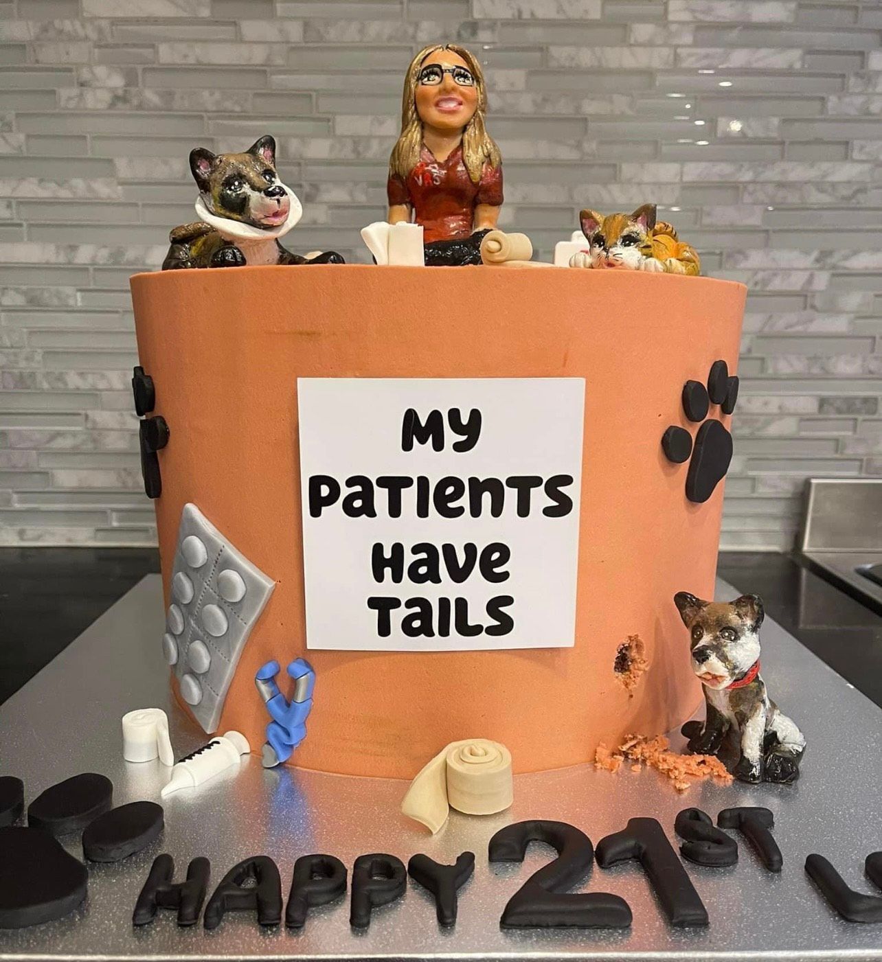A cake that says ' my patients have tails ' on it