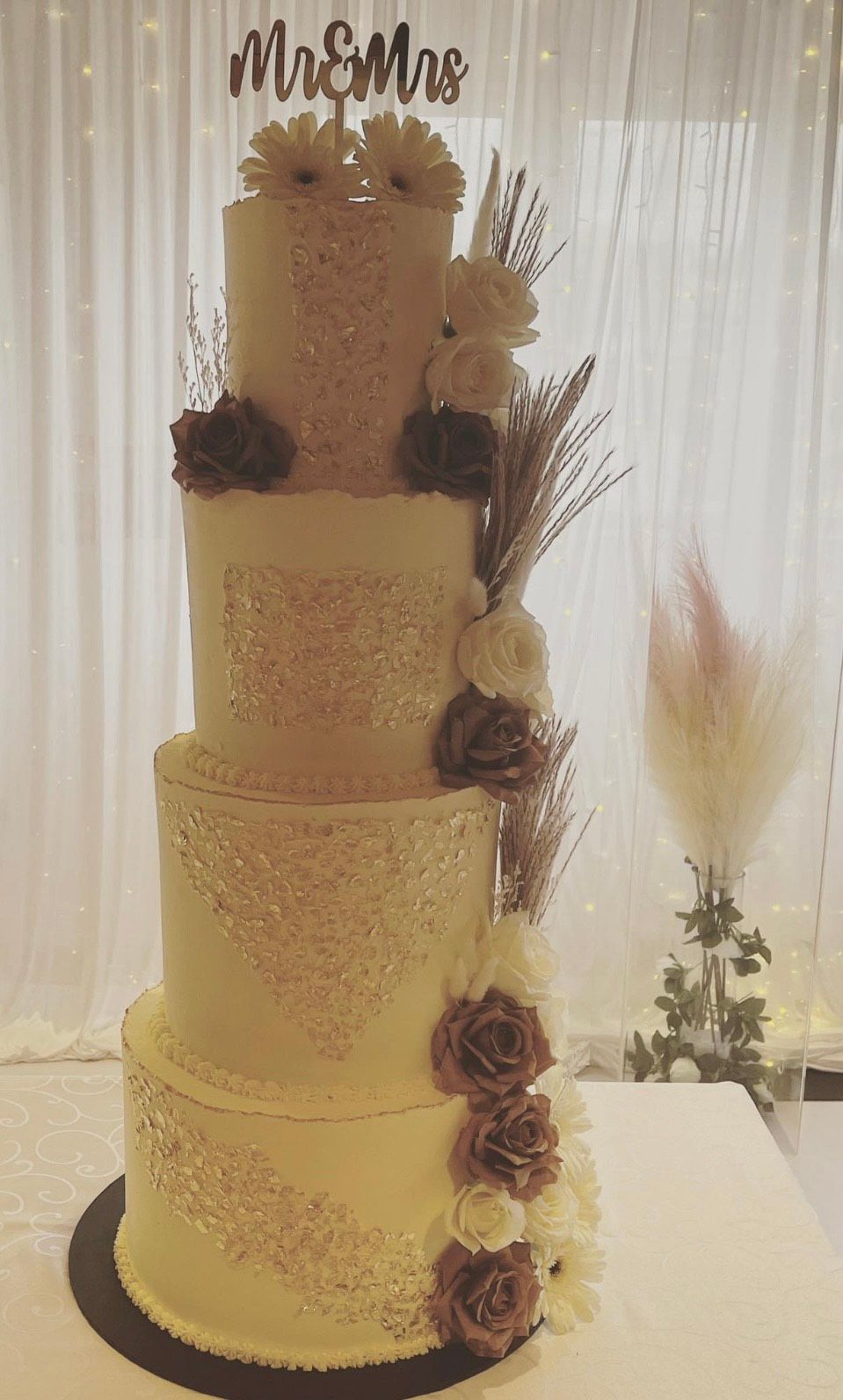 A wedding cake is sitting on top of a table.