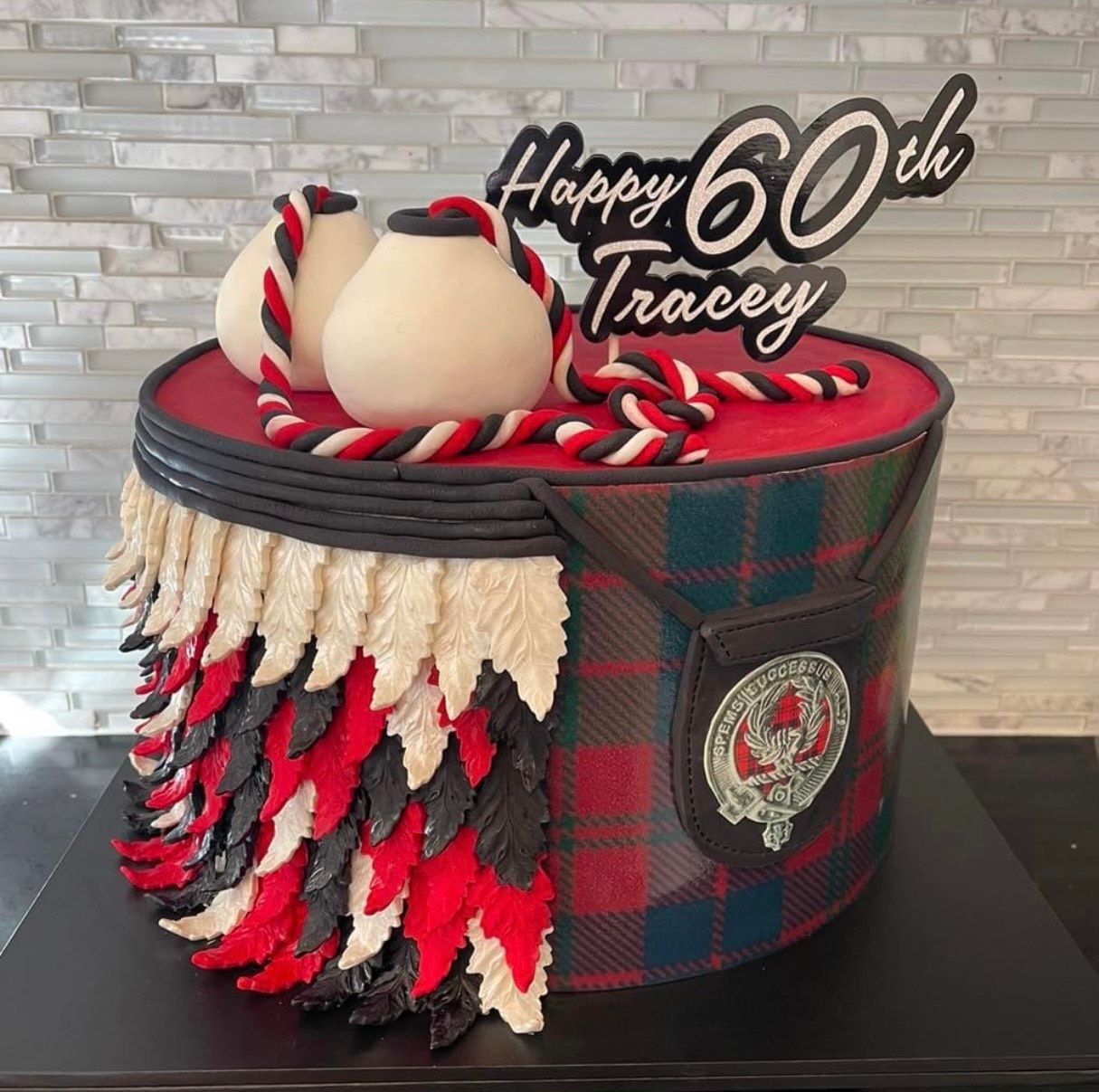 A cake that looks like a bagpipe is sitting on a table.