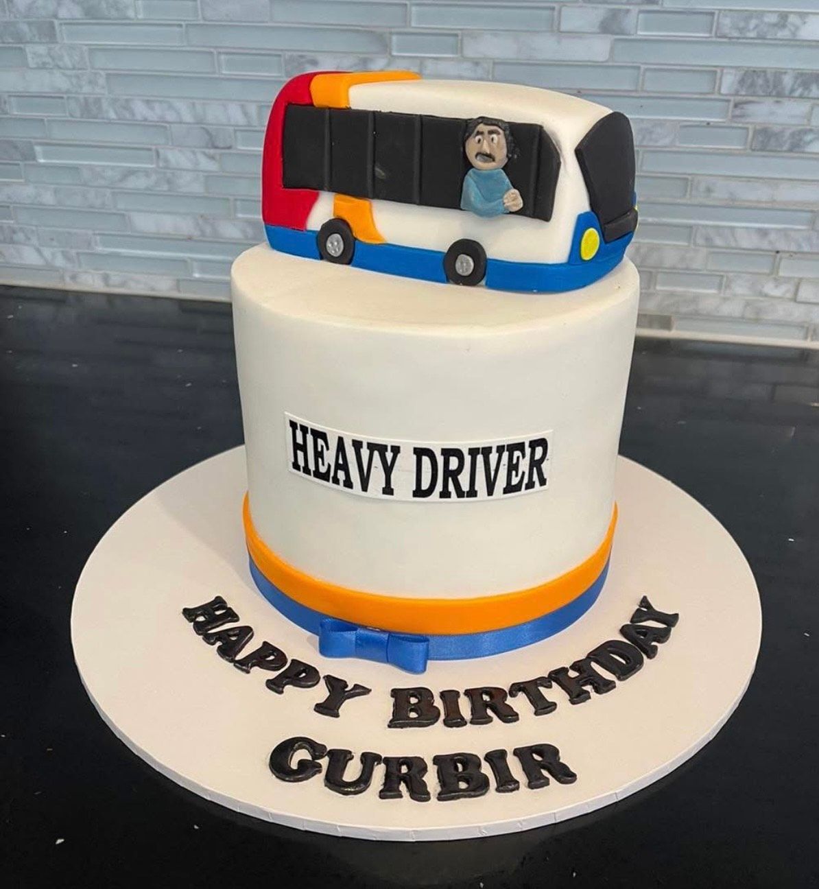 A birthday cake for a heavy driver with a bus on top