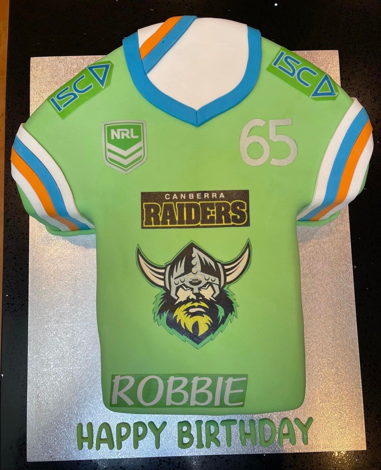 A birthday cake in the shape of a raiders jersey